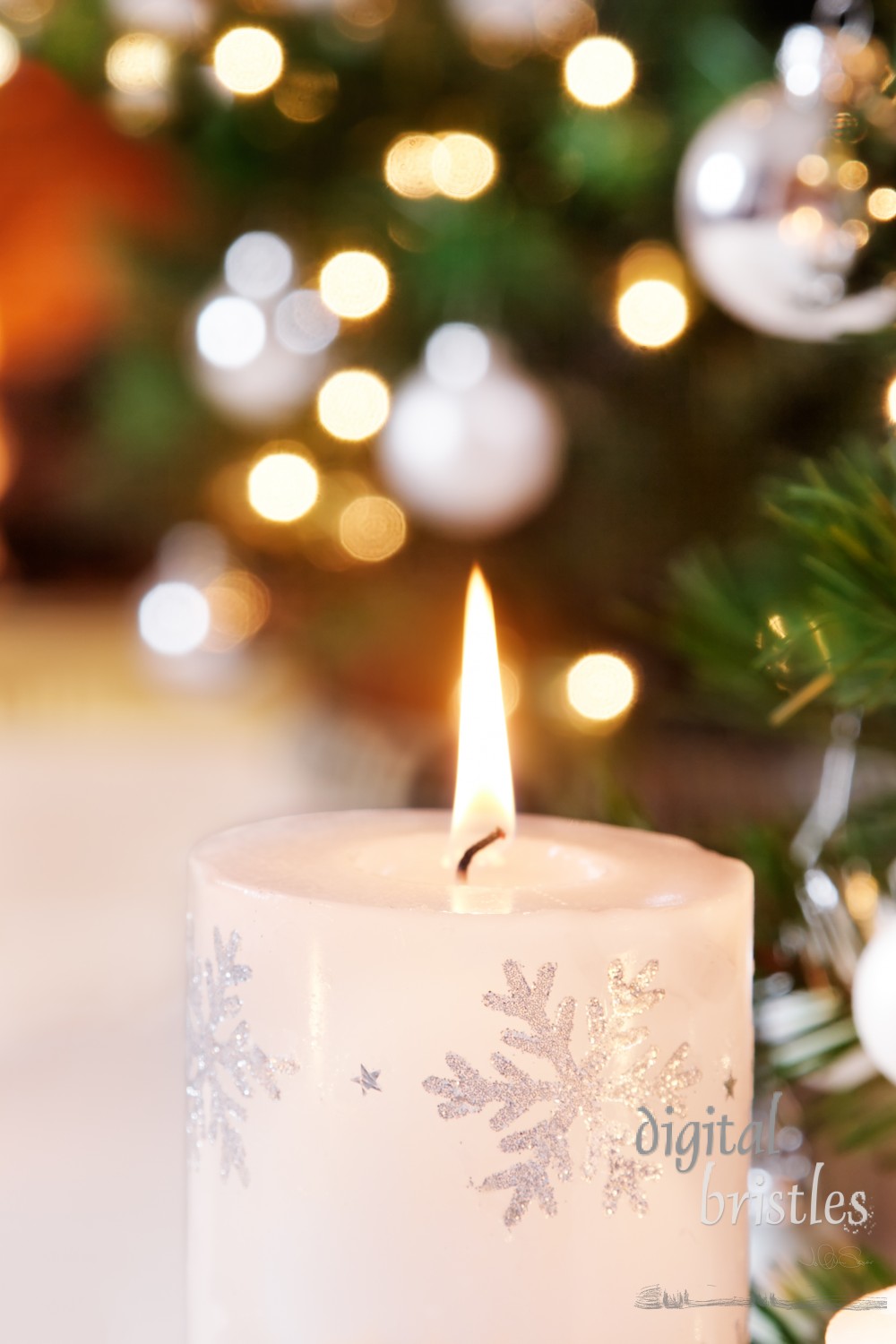 Snowflake candle and glittering Christmas tree decorations