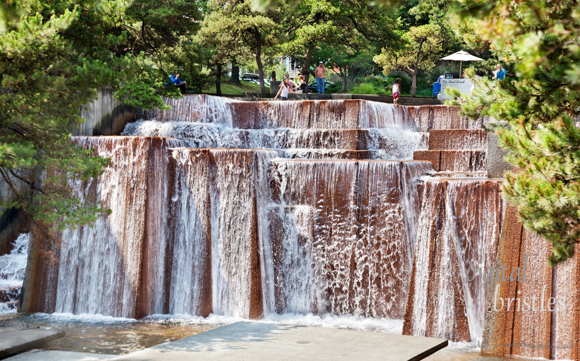 Waterfalls fill a city block at Keller Fountain Park, SW 3rd Ave & Clay St. Built in 1970, the terraces and platforms suggest Pacific Northwest waterfalls where families cool off on a hot summer afternoon and others eat lunch outside.