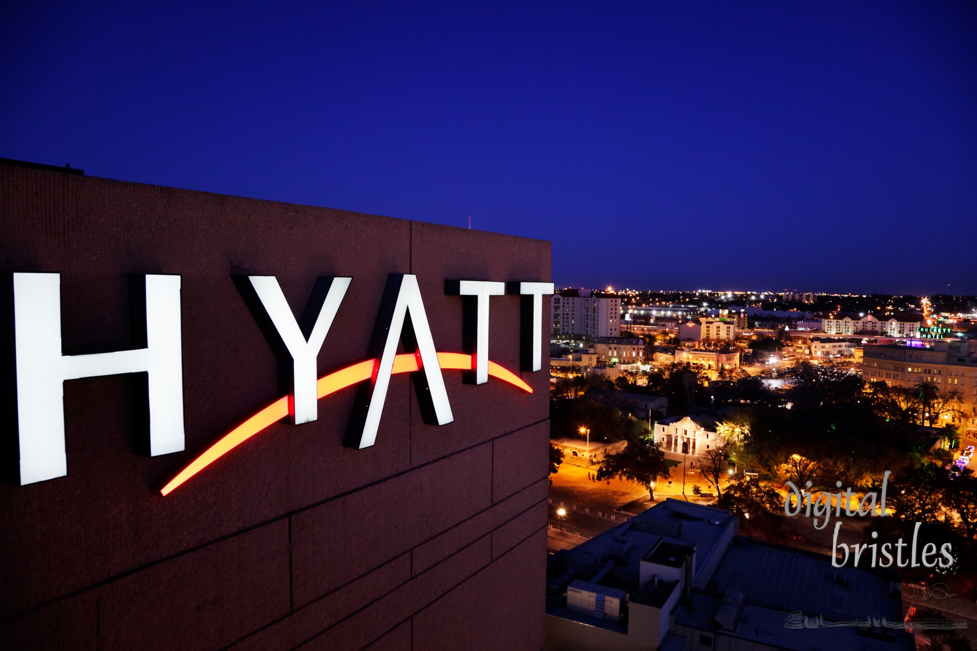 Illuminated sign for the Hyatt Regency hotel, 123 Losoya Street, overlooking Alamo plaza in this view and the Riverwalk on the other side. The  16 storey, 632 room hotel was built in 1981 and rennovated in 2004.