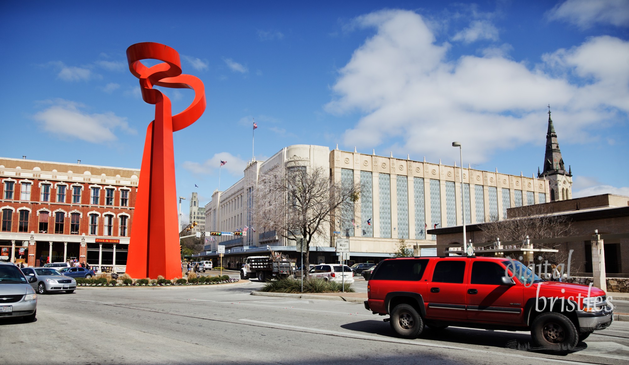 Abstract red sculpture by Sebastian, called the Torch of Friendship, sits at the intersection of Losoya, Alamo, and Commerce streets in downtown San Antonio. The 65 foot high enameled iron sculpture was commissioned by the Association of Mexican Entrepreneurs of San Antonio and presented by the Government of Mexico to the City of San Antonio in June 2002