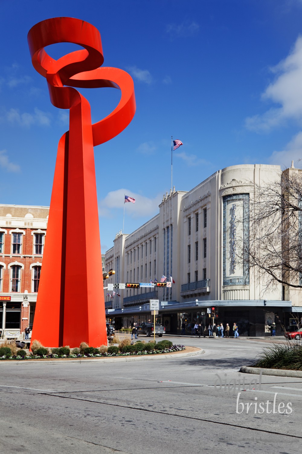 Abstract red sculpture by Sebastian, called the Torch of Friendship, sits at the intersection of Losoya, Alamo, and Commerce streets in downtown San Antonio. The 65 foot high enameled iron sculpture was commissioned by the Association of Mexican Entrepreneurs of San Antonio and presented by the Government of Mexico to the City of San Antonio in June 2002