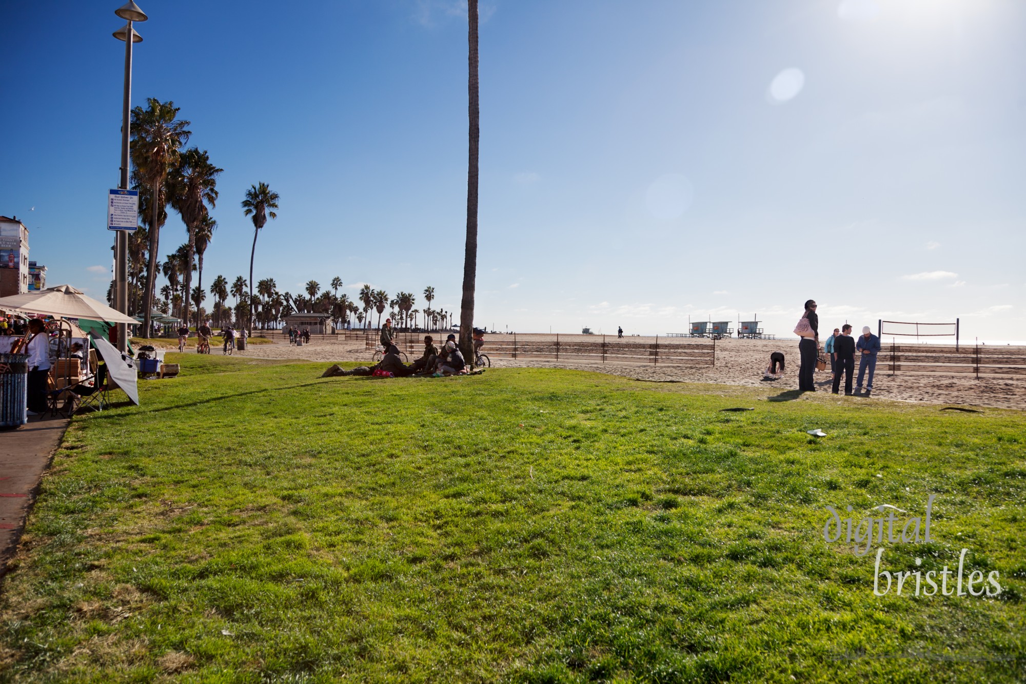 The park and South Bay bicycle trail next to the Boardwalk (Ocean Front Walk) on Venice Beach. A popular tourist destination, with sidewalk vendors & performers, Venice Beach also has a homeless population sharing the park between the boardwalk and the beach.