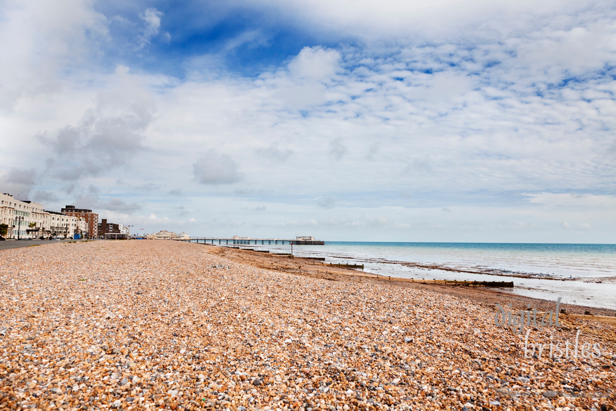 Wide shot of Worthing beach at low tide, with the Victorian pier in the distance