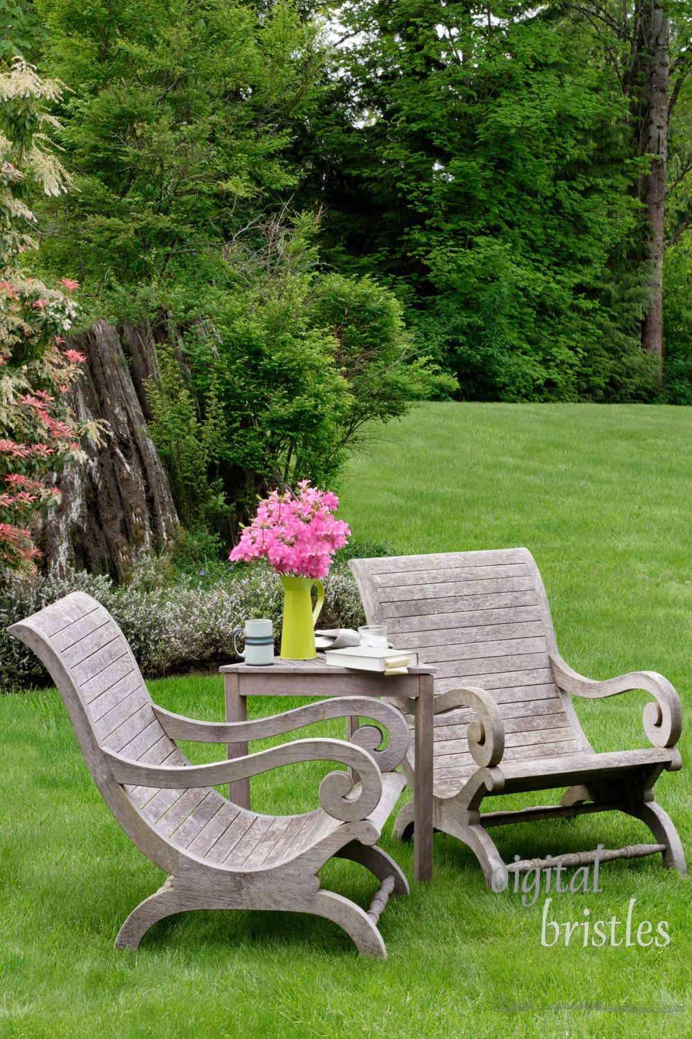 Wooden garden chairs in a green spot in the garden, vertical