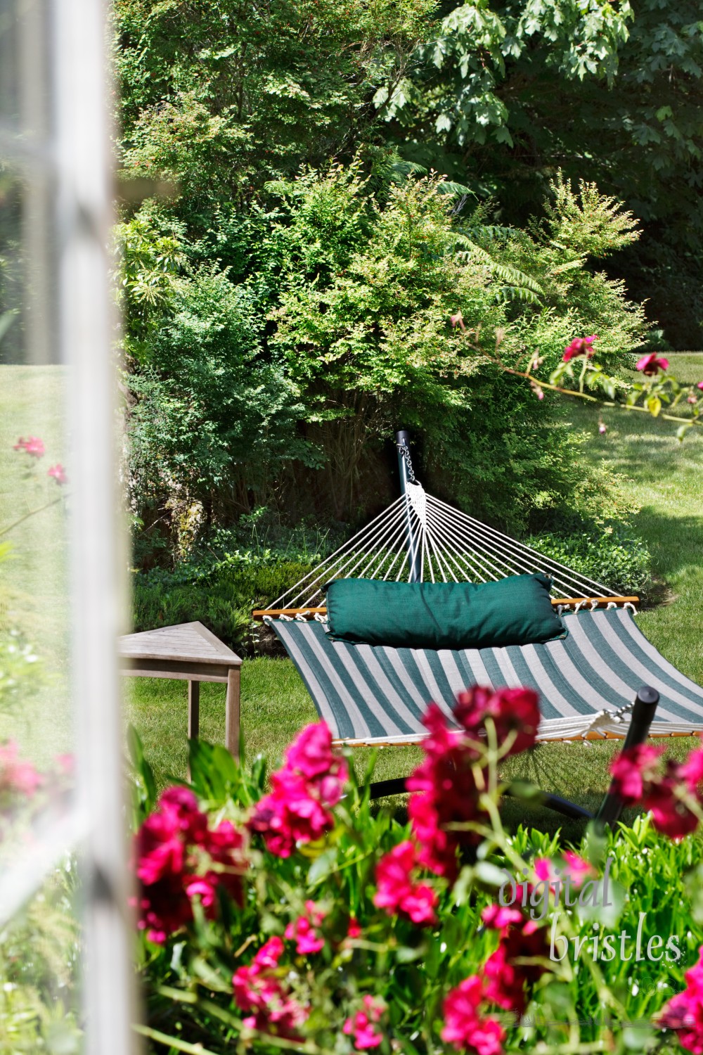 View through a window to a garden hammock