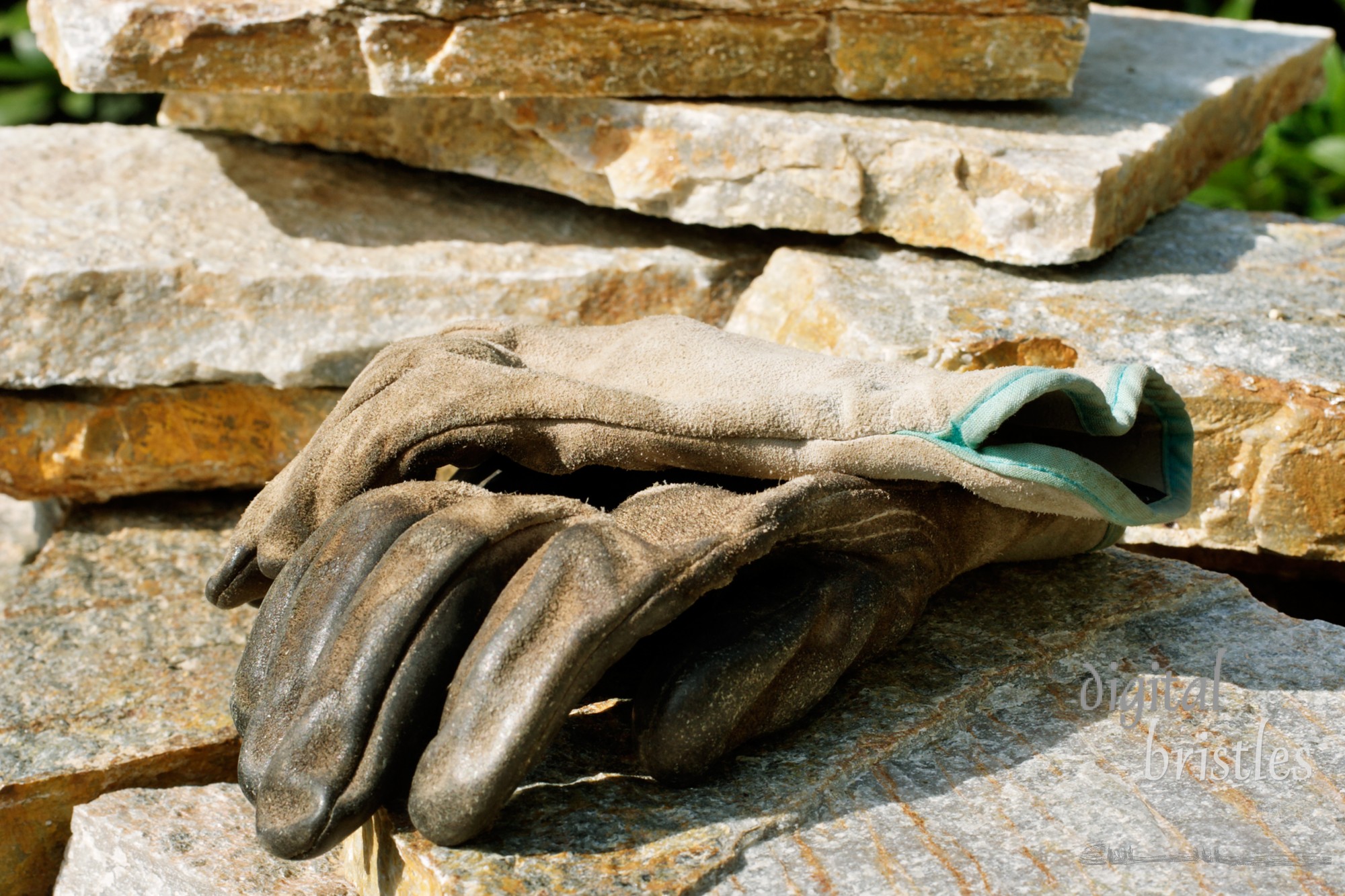 Paving stones and well worn gardening gloves