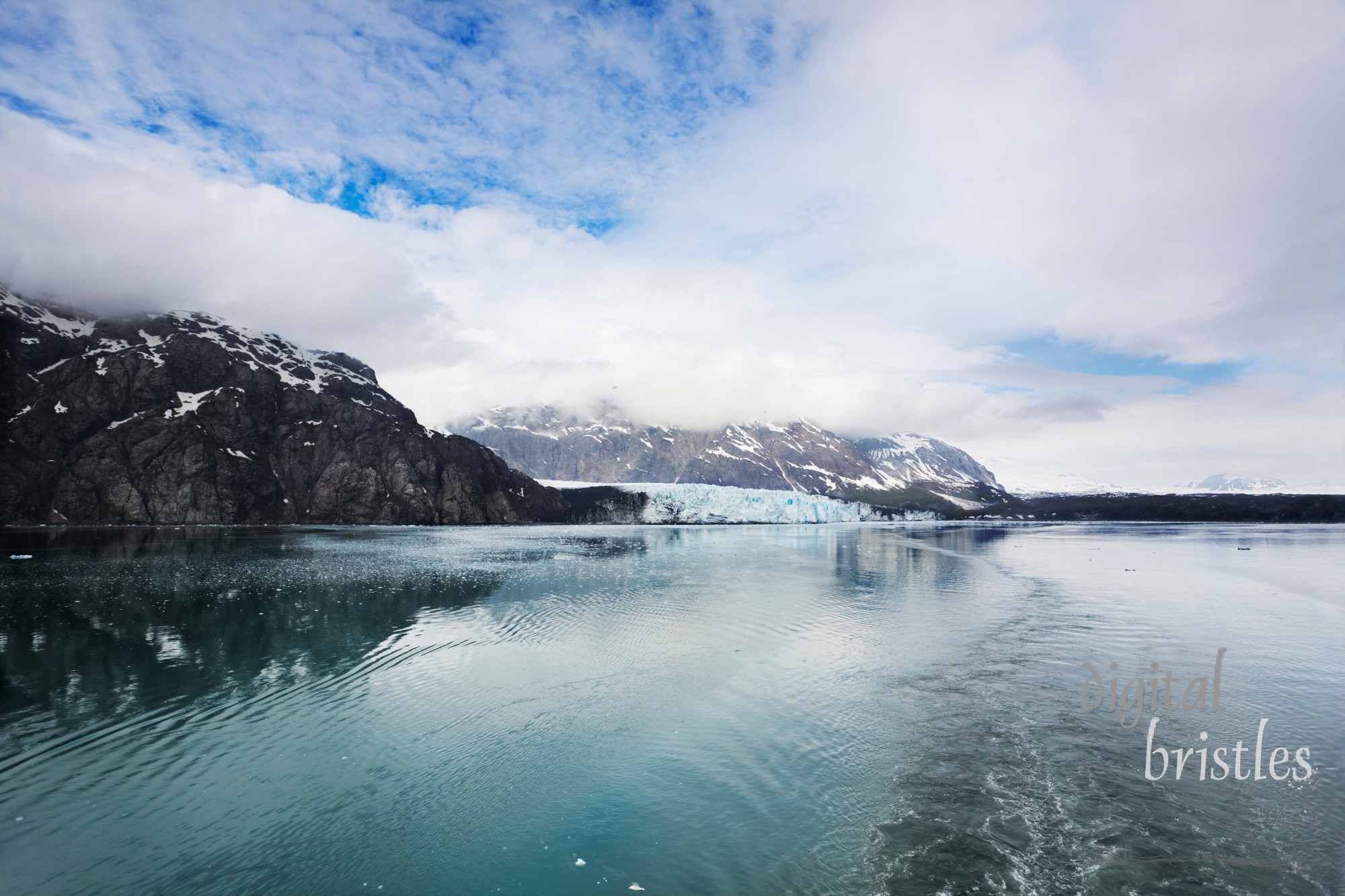 Boat's wake curves away from Margerie Glacier, Glacier Bay National Park, Alaska