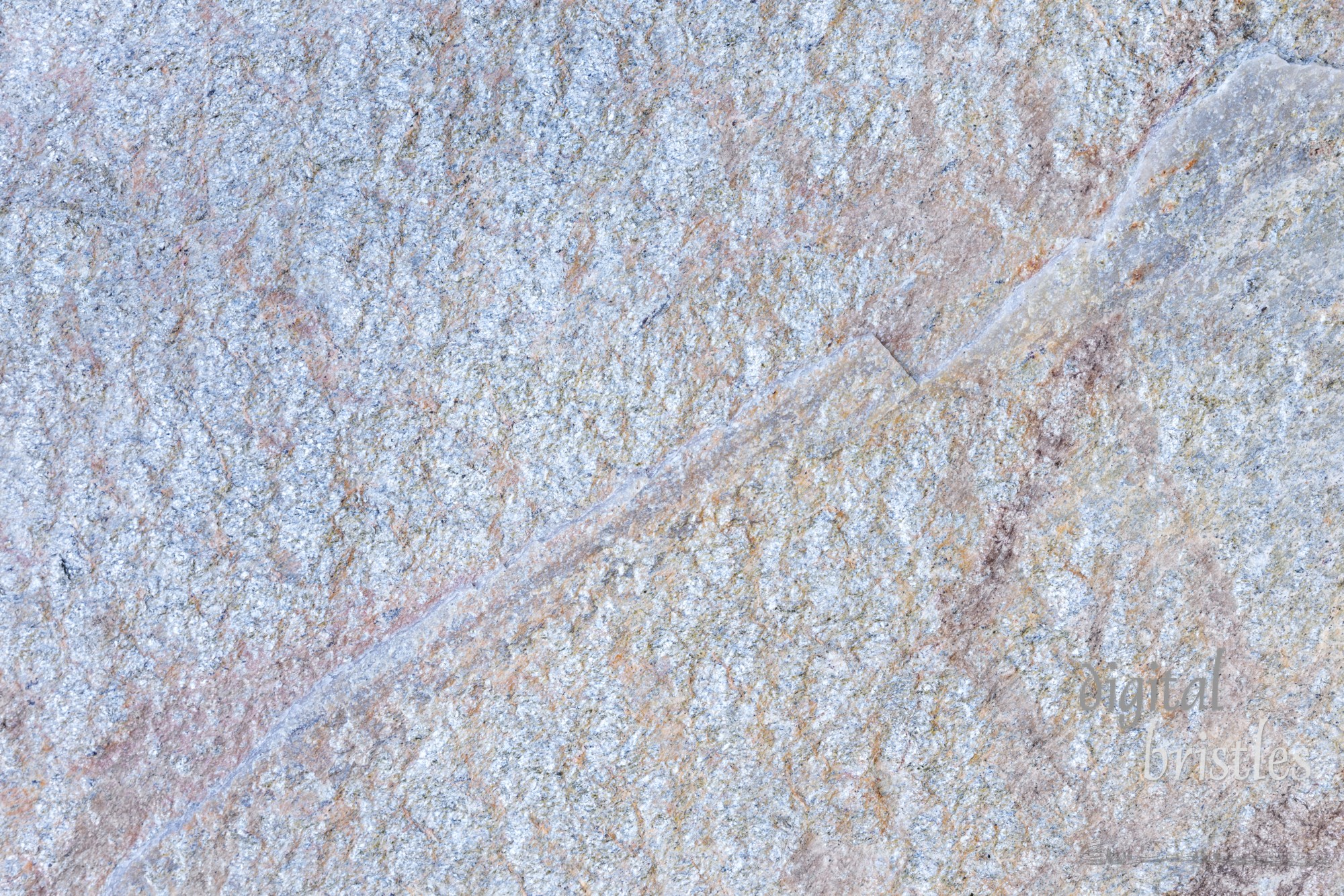 Rough, silvery textured stone surface