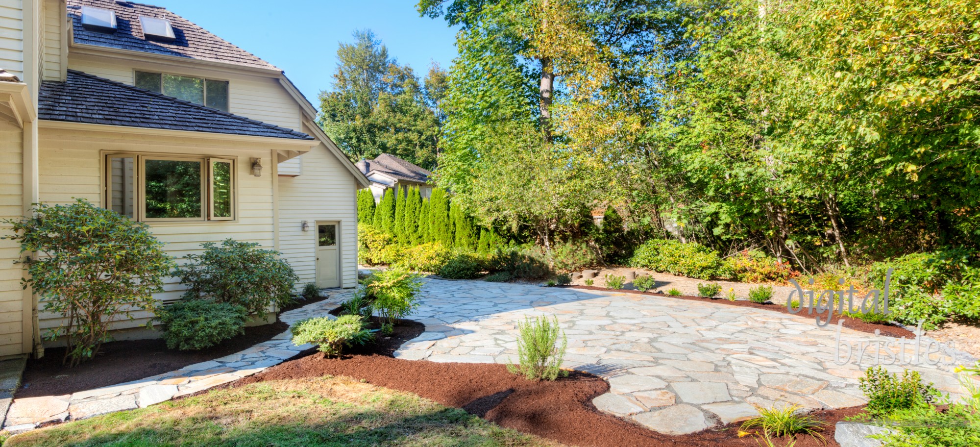 Path, patio and flowerbeds complete, with plants transplanted and mulched