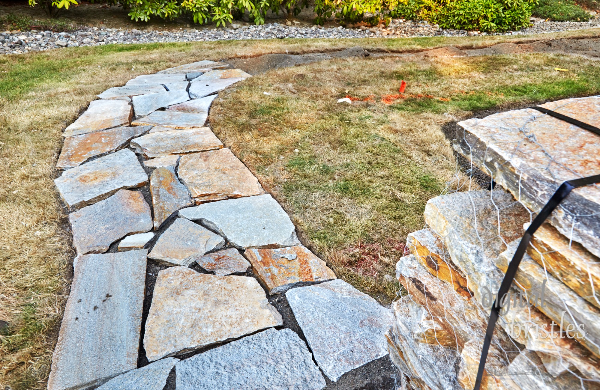 Pavers arranged along the path  in preparation for gravel filler