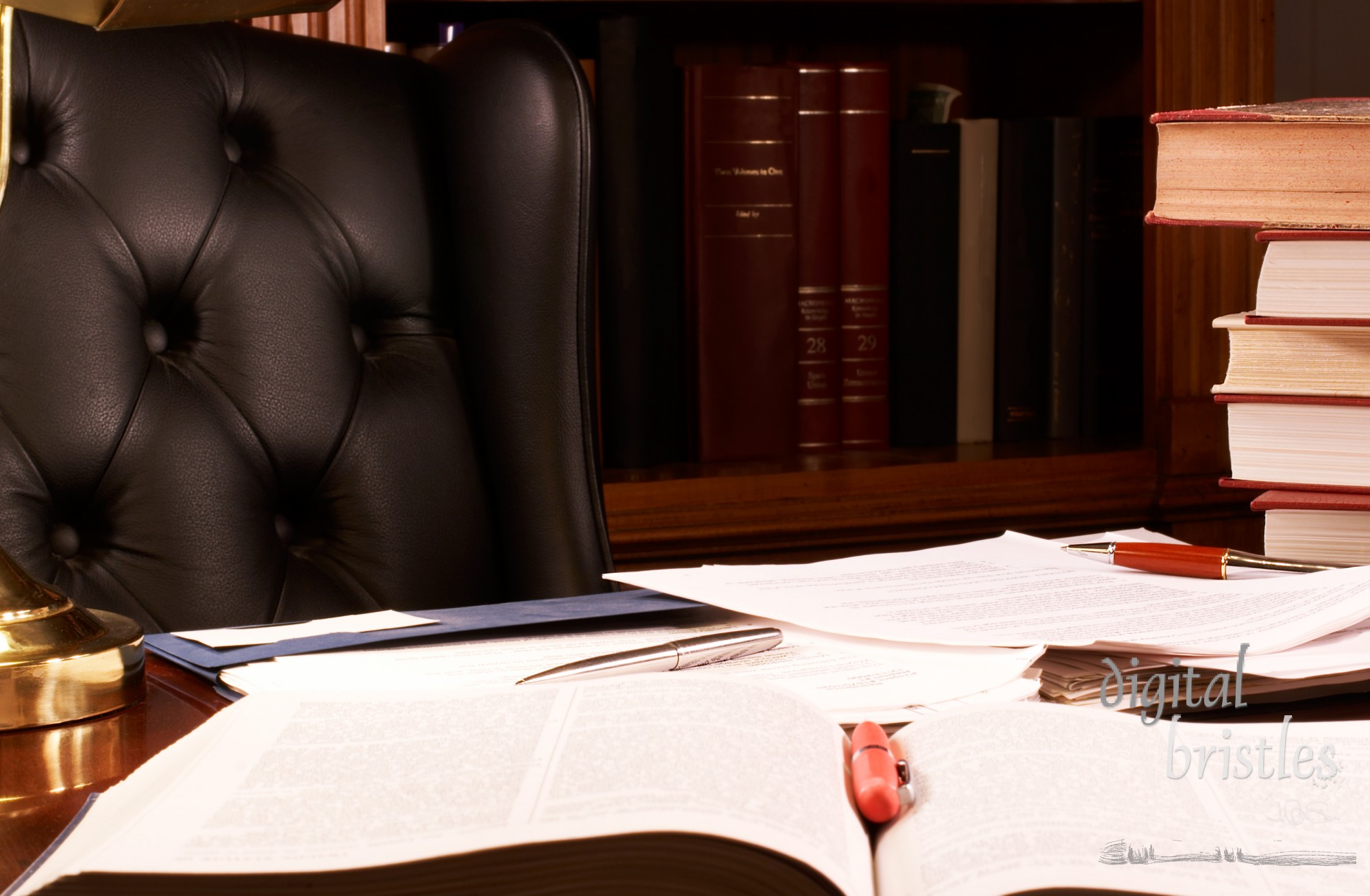 Books and papers piled on a desk