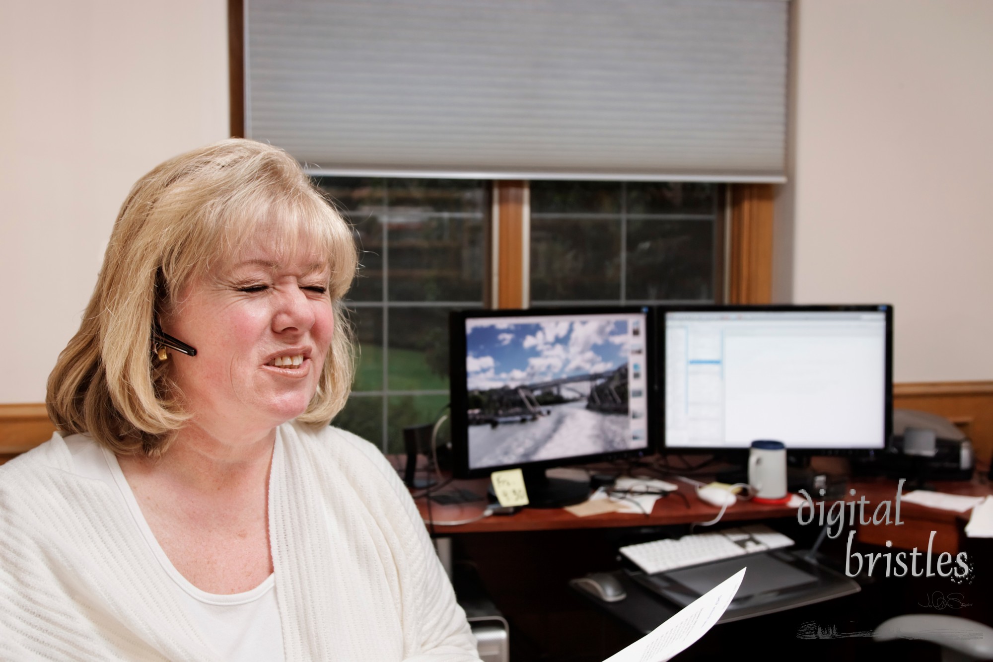 Mature woman reacts to her phone conversation in her home office