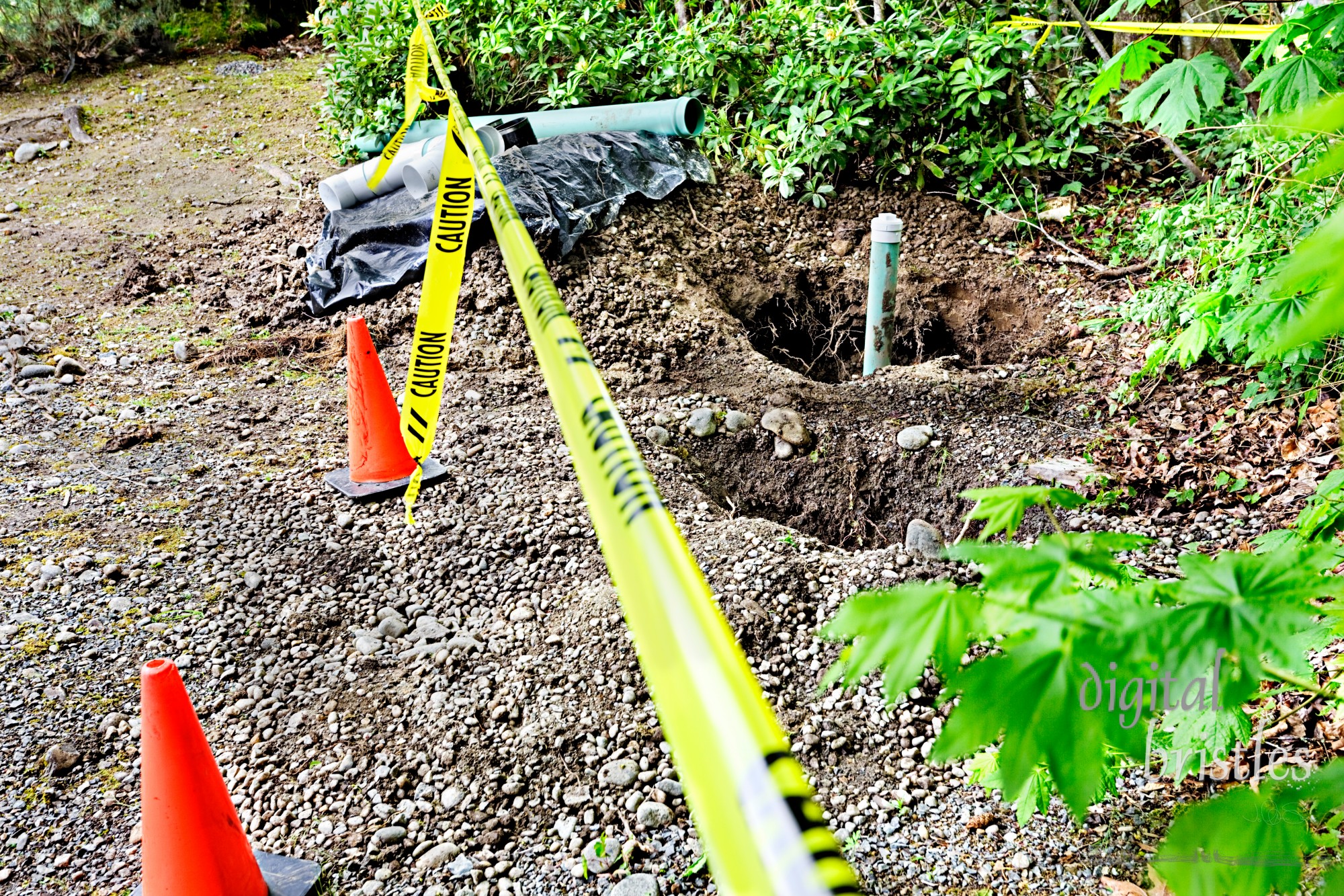 Holes for groundwater drainage pipes, cordon tape and cones for safety