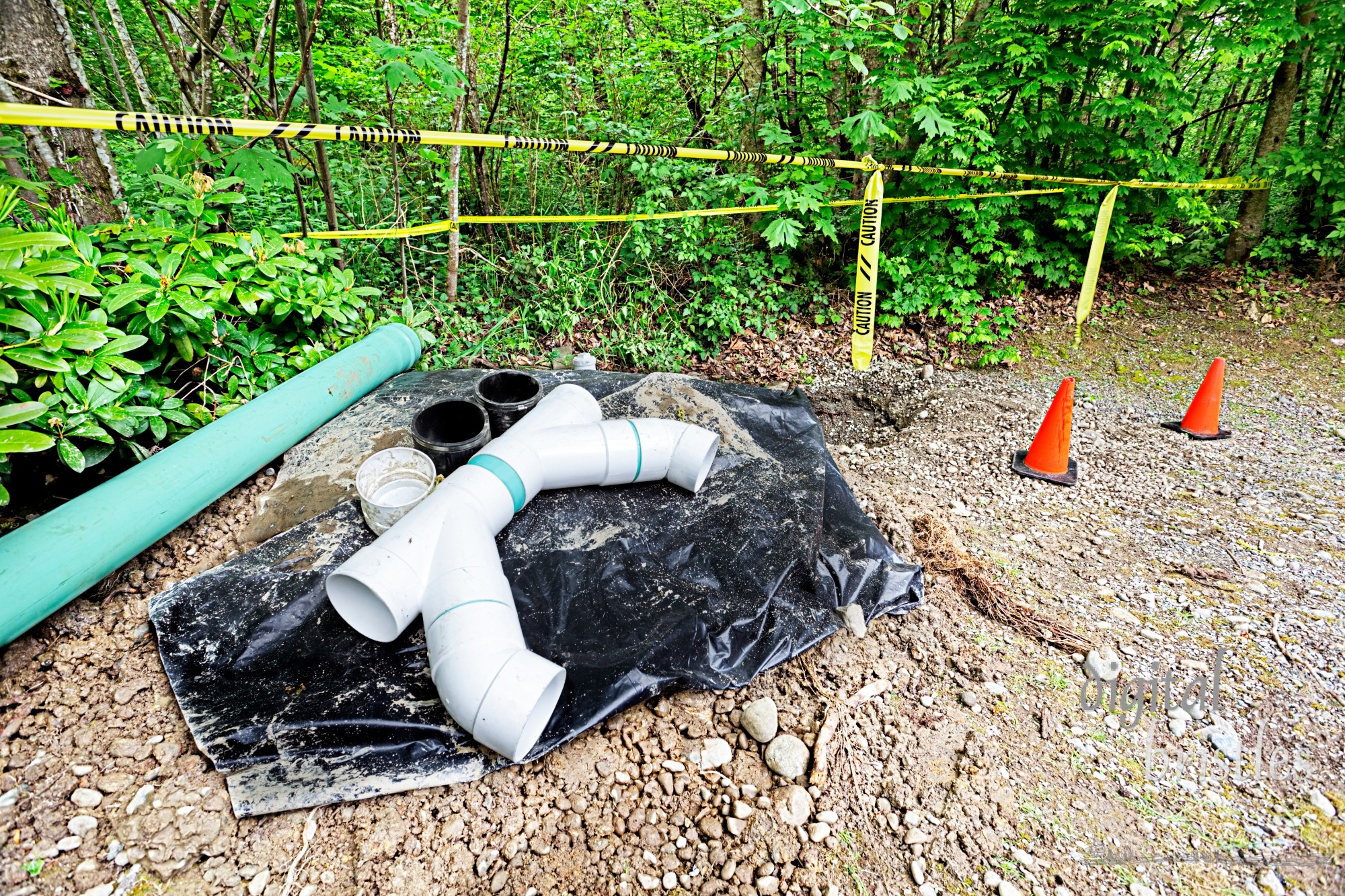 Caution tape surrounds work area in home groundwater drainage maintenance project