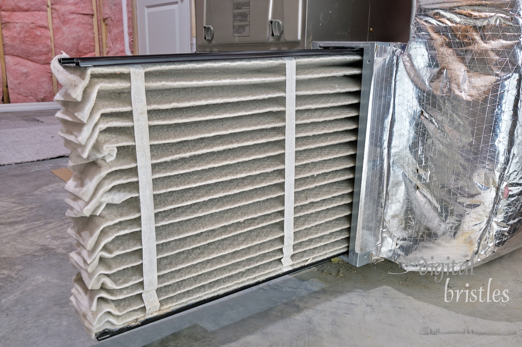 High efficiency furnace air filter pulled out for inspection and cleaning