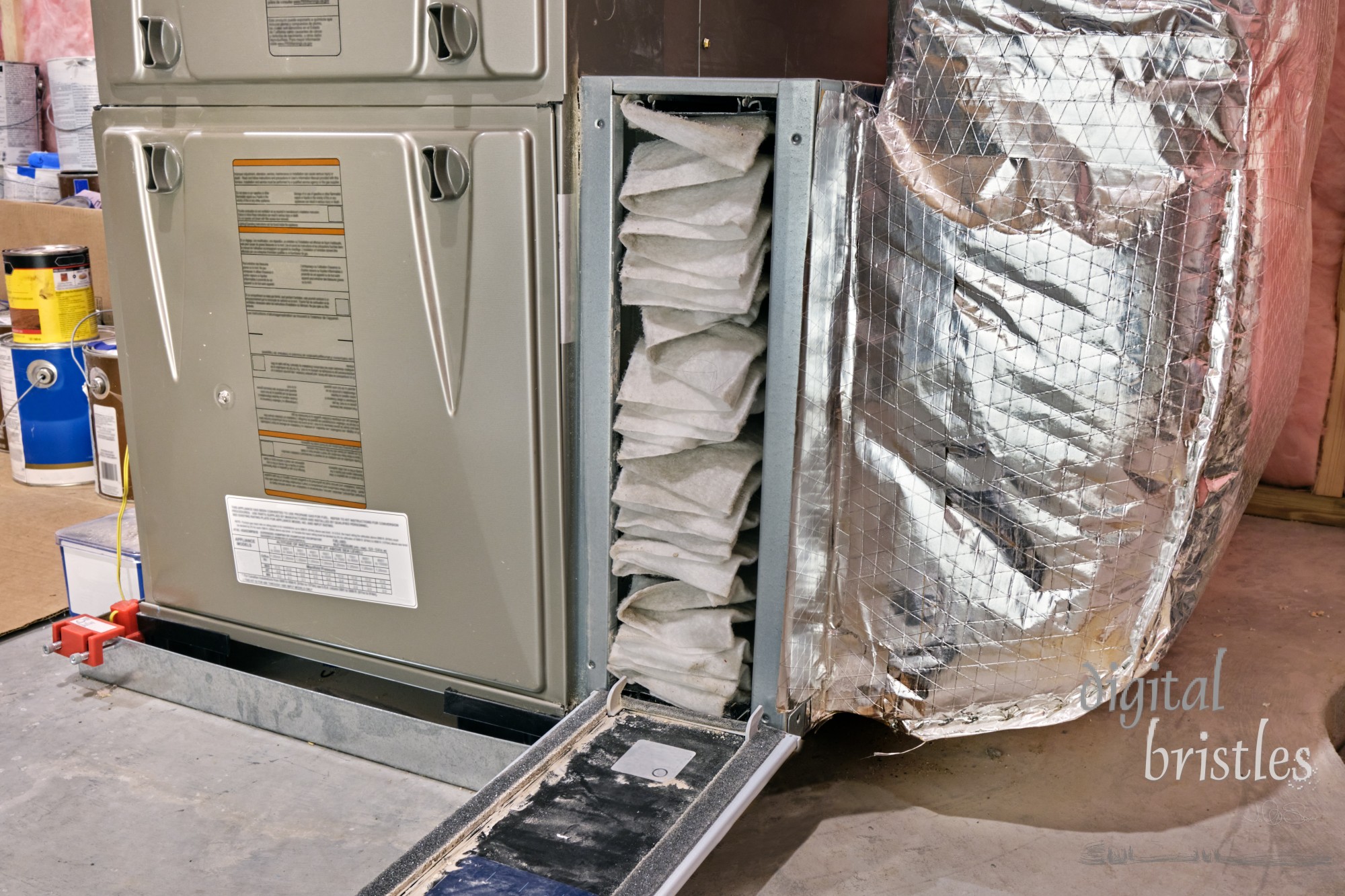 Furnace air filter opened for inspection and cleaning or replacement