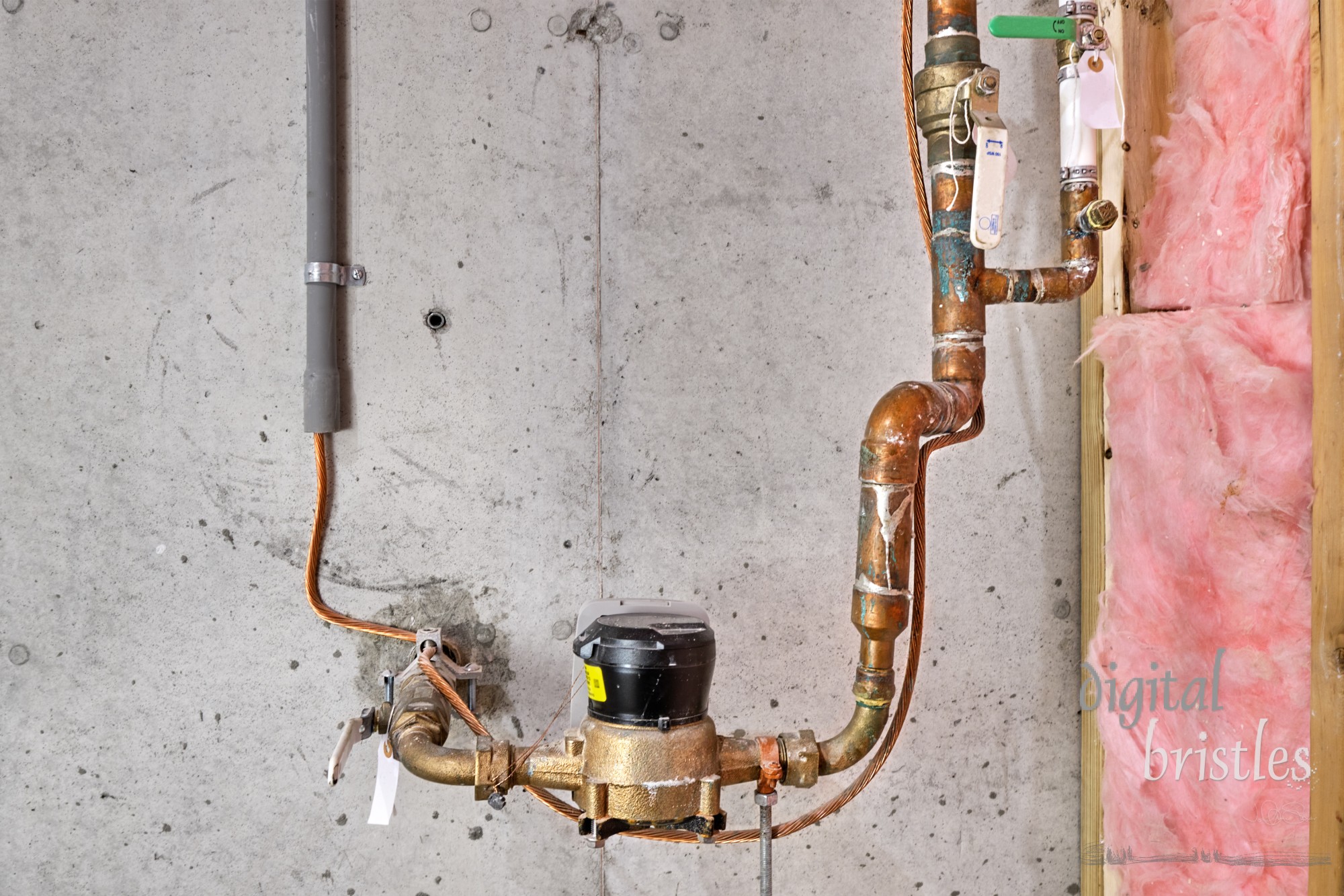 Home's main water line, meter, shutoff valves and copper grounding wire with clamp