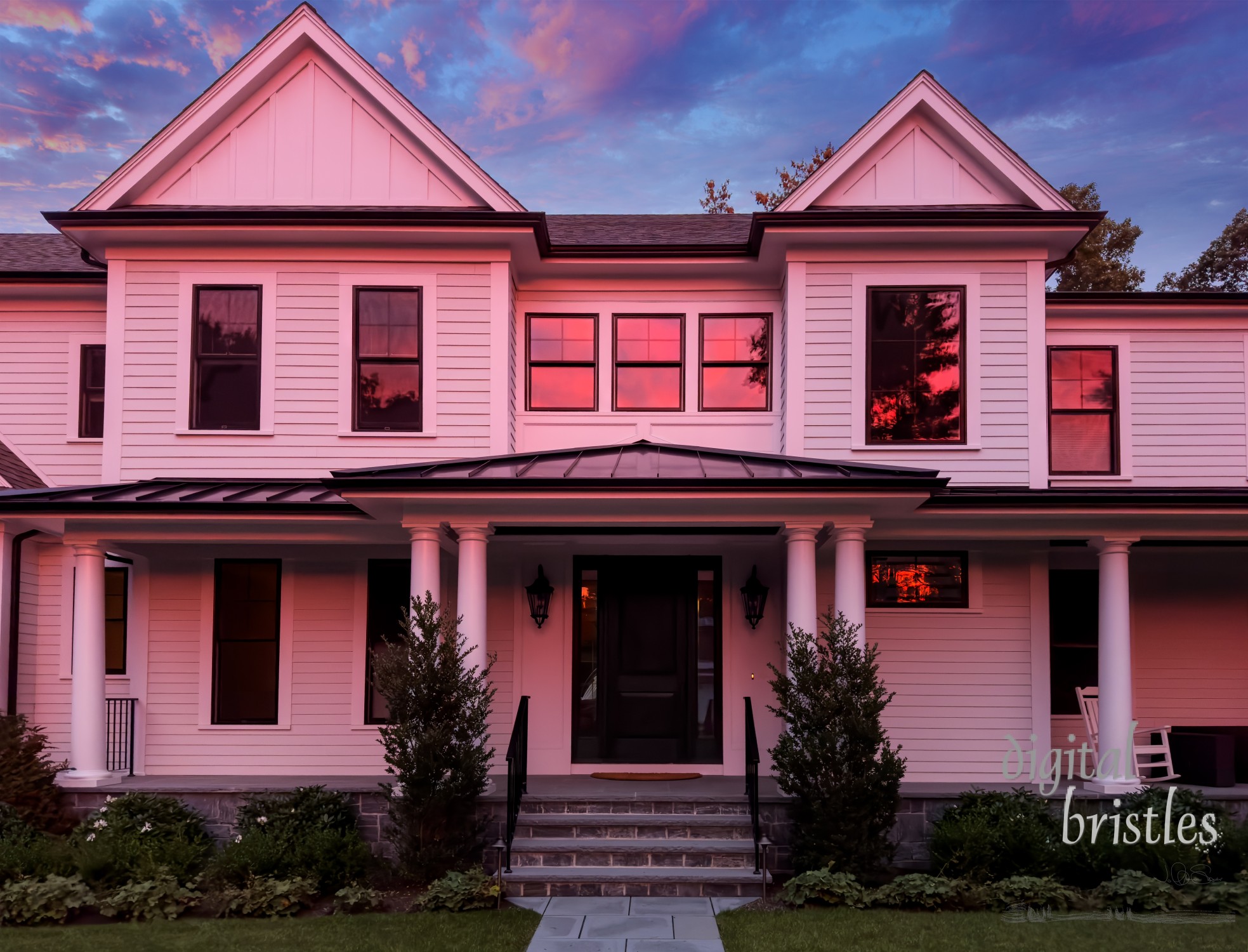 Suburban home turned pink by the light of the setting sun