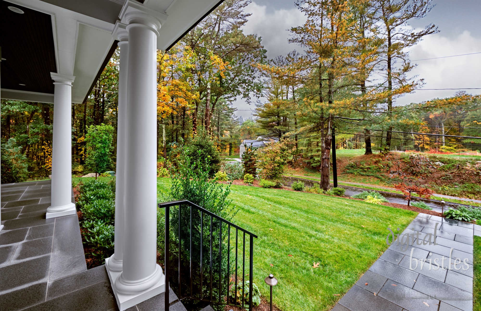 Front porch of suburban New England home on a cloudy and wet fall morning