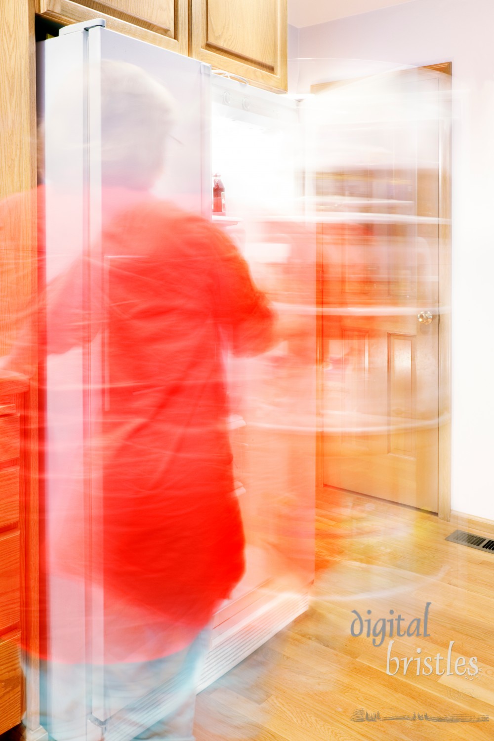 Woman busily moving about - getting things out of the refrigerator