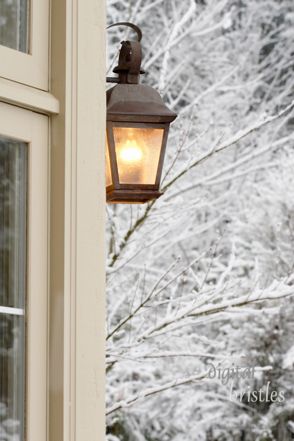 Porch light lit on a snowy afternoon