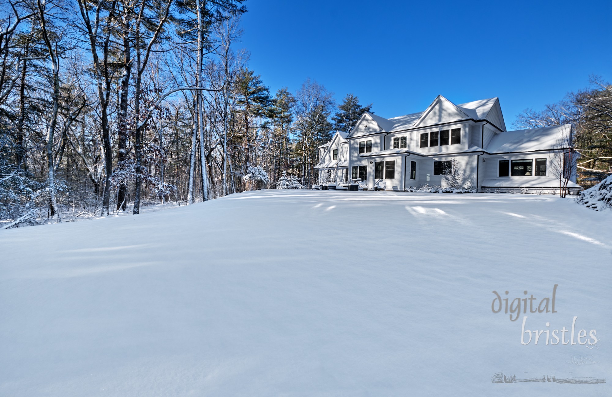 Suburban home on a cold, sunny Winter morning with the back yard covered in snow