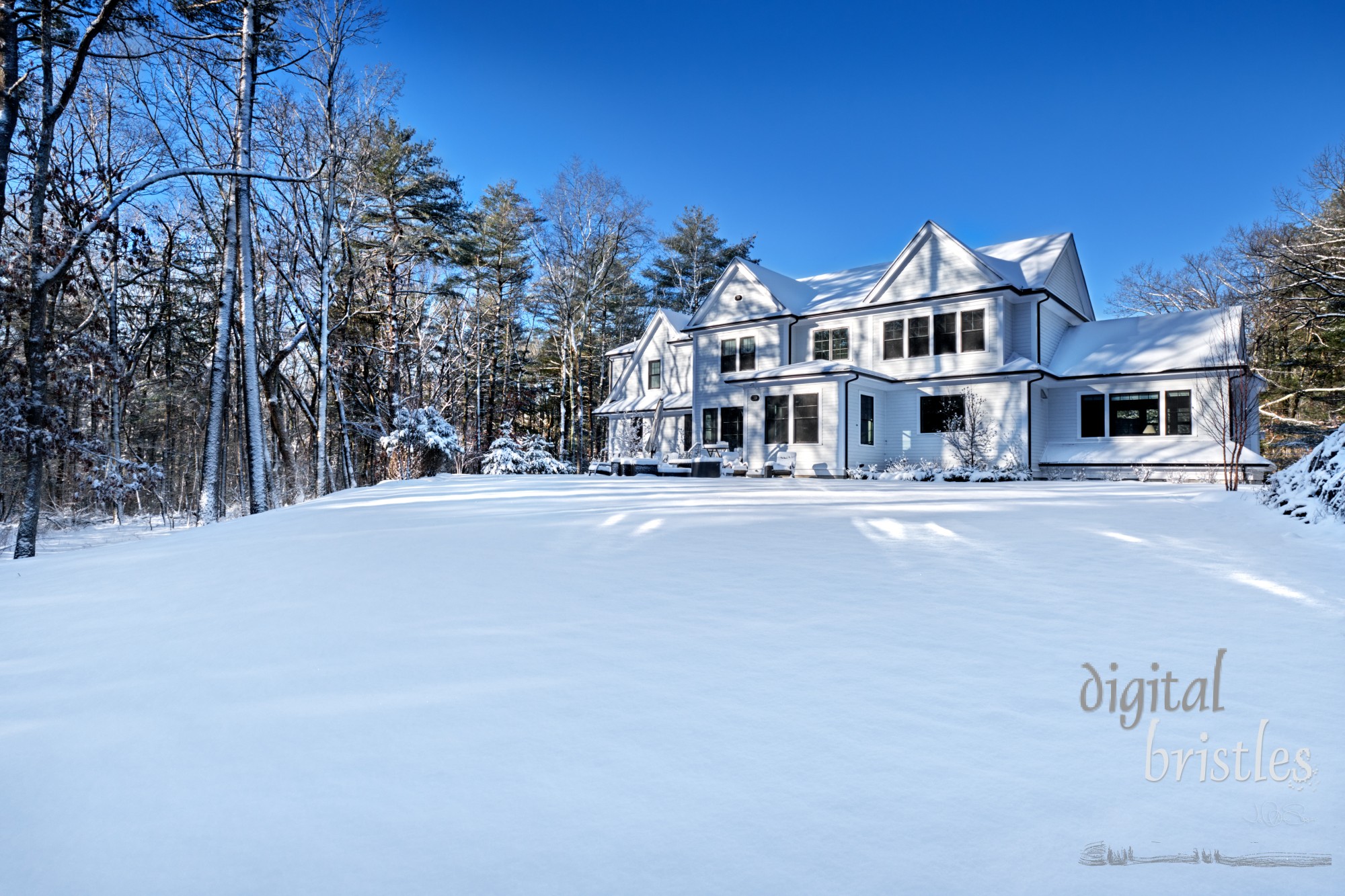 Suburban home in the winter sunshine on a snowy morning