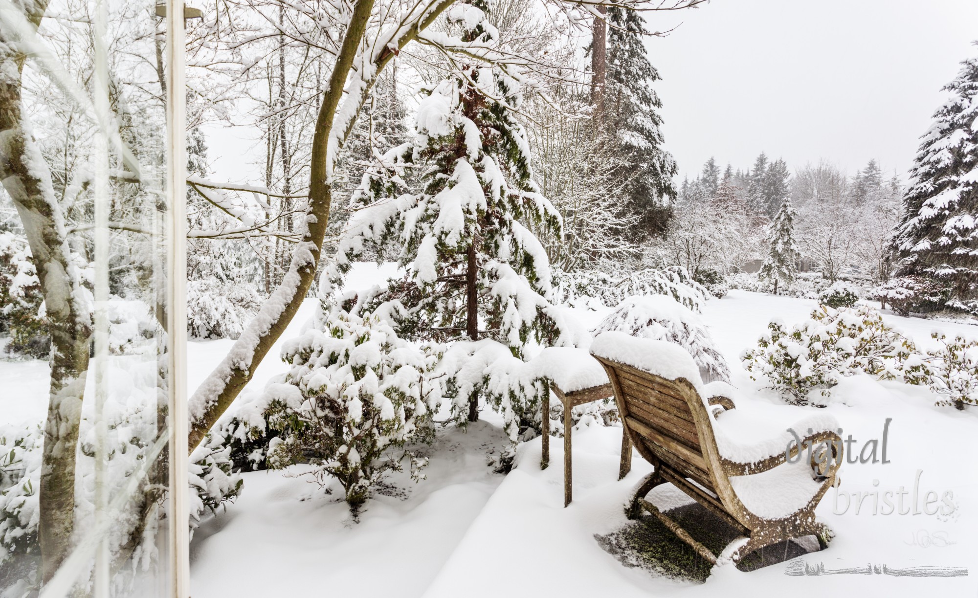 Window open to snow falling in a snow-covered garden