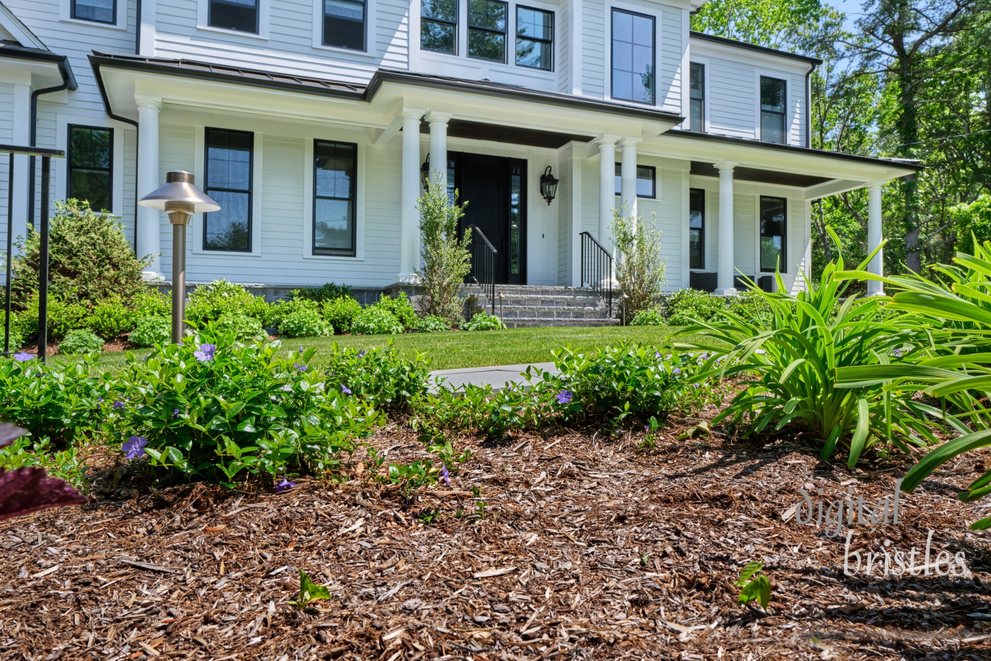 Pretty suburban front garden freshly mowed, weeded and mulched