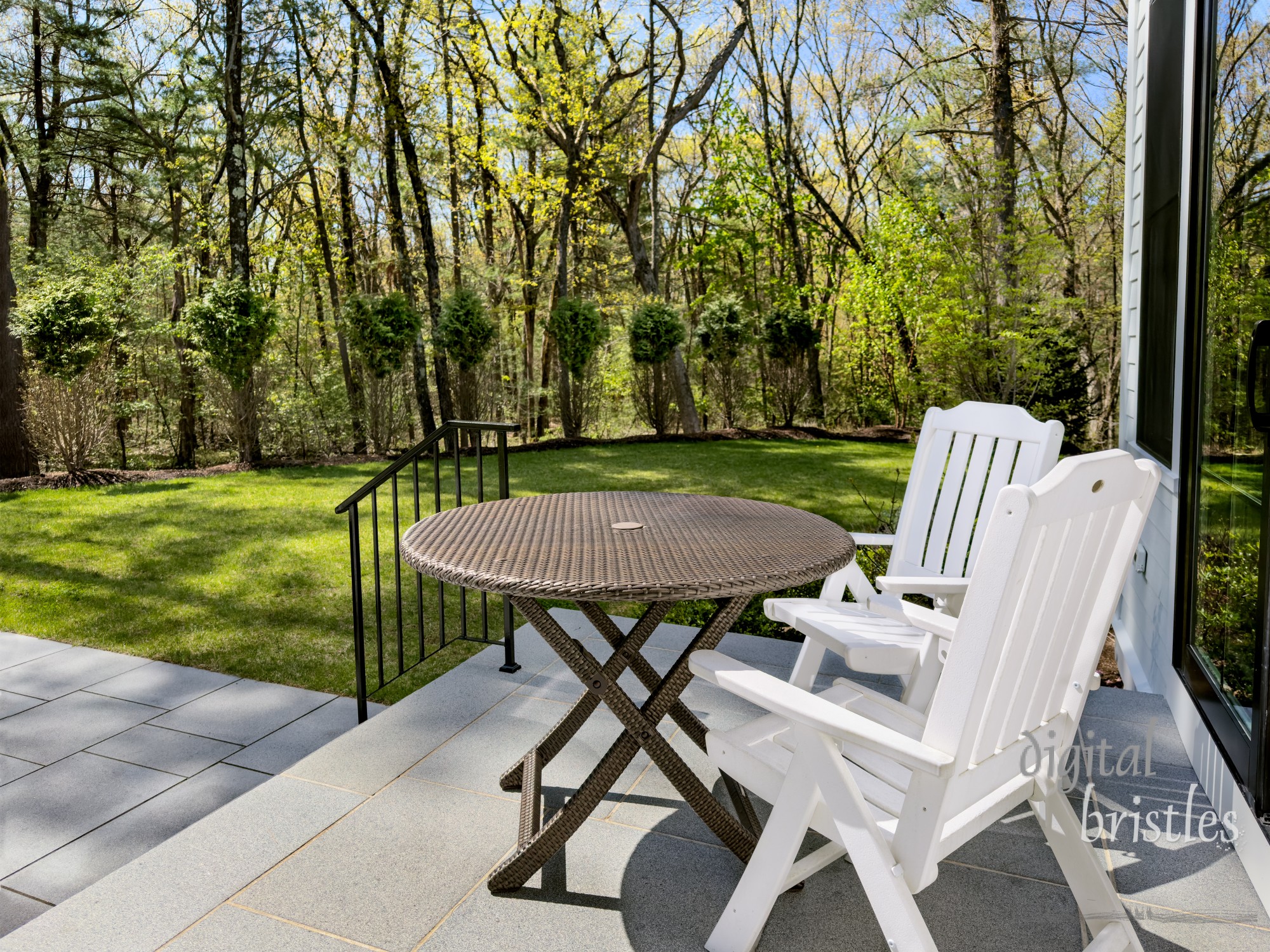 Table and chairs on a sunny patio in a suburban garden on a bright and sunny Spring morning