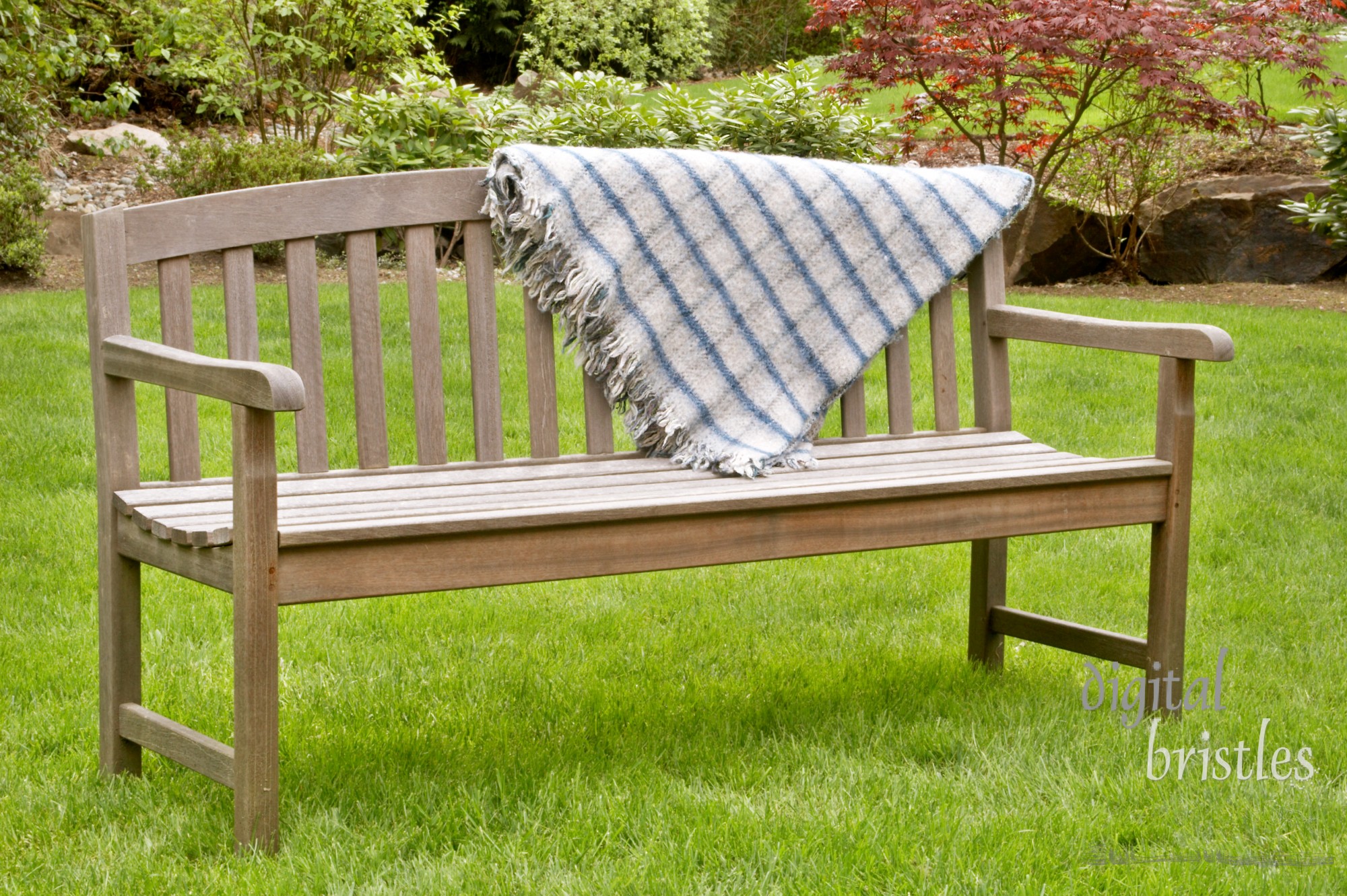 Wooden bench with picnic blanket