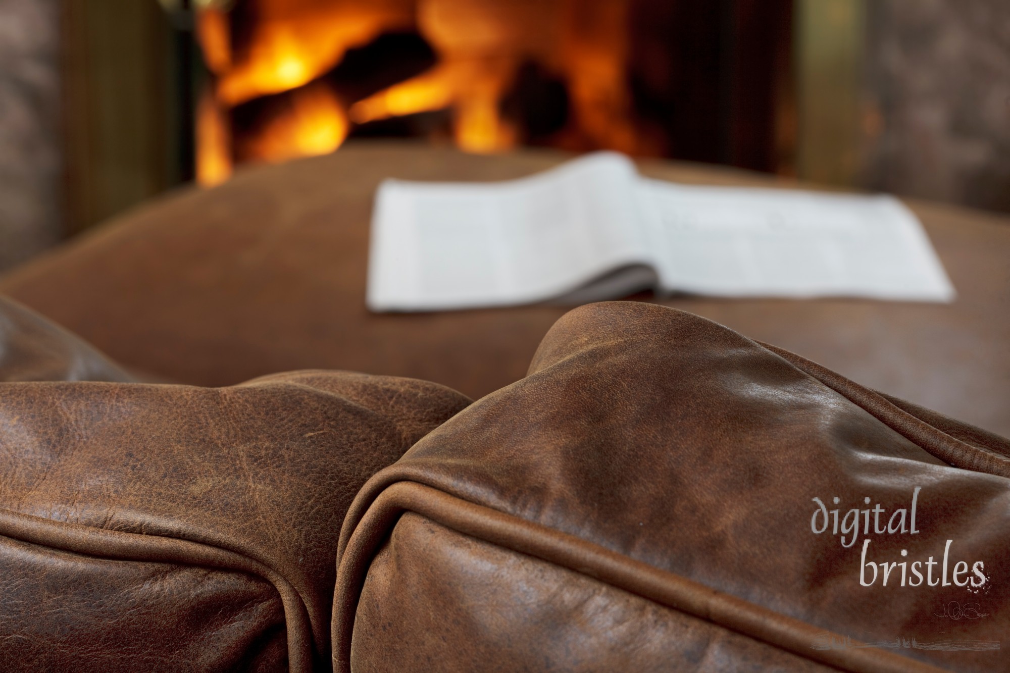 Soft brown leather sofa by a warm fire