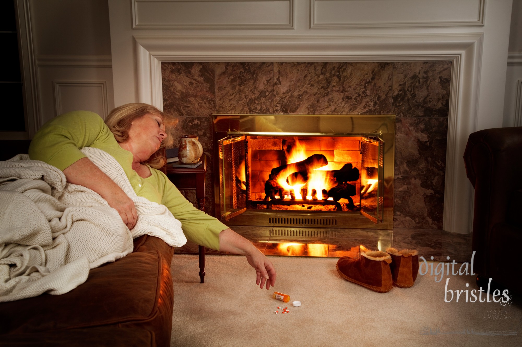 Woman sleeping on the sofa by the fire with spilled pill bottle on the carpet