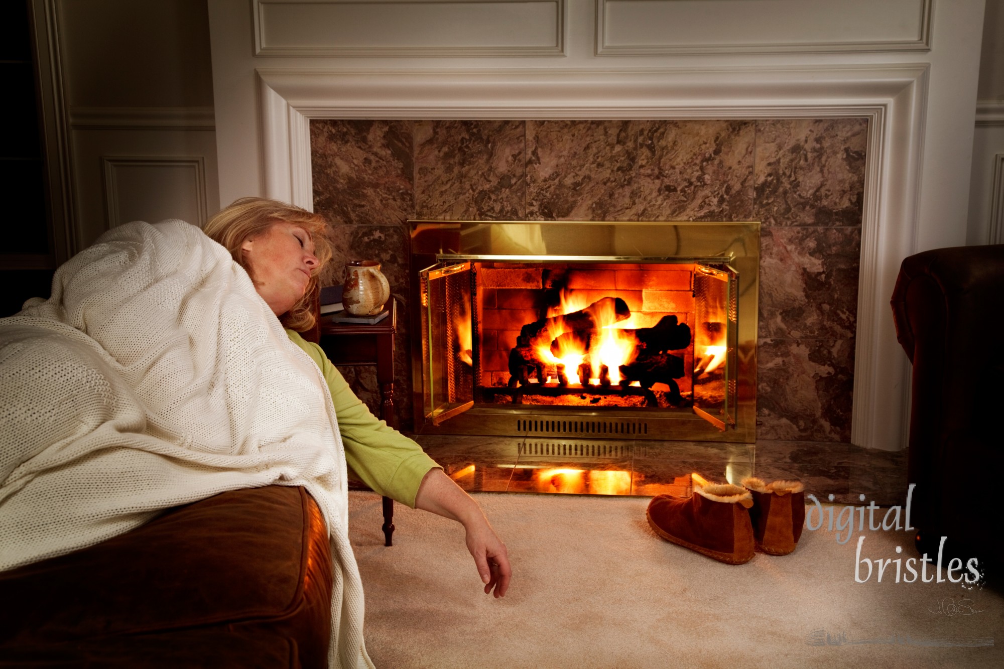 Woman sleeping on the sofa by the fire in a dark living room