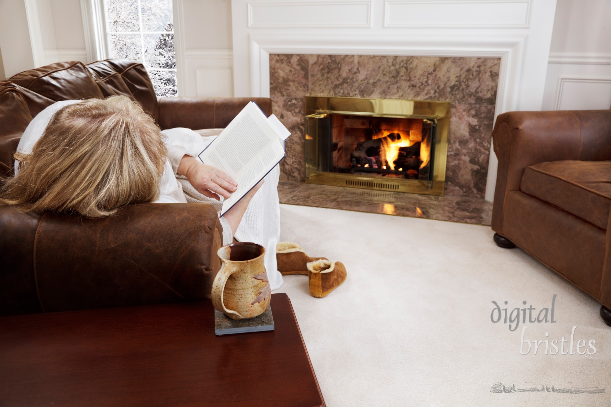 Woman reading by a cozy fire