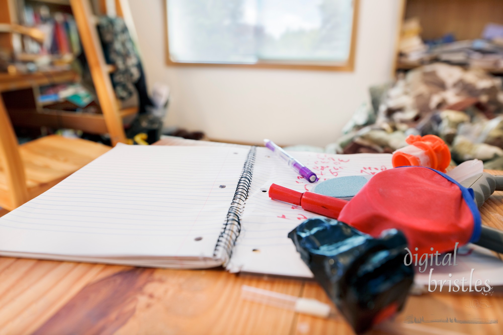 Teenage boy's messy room. Tilt shift lens, with focus on notebook