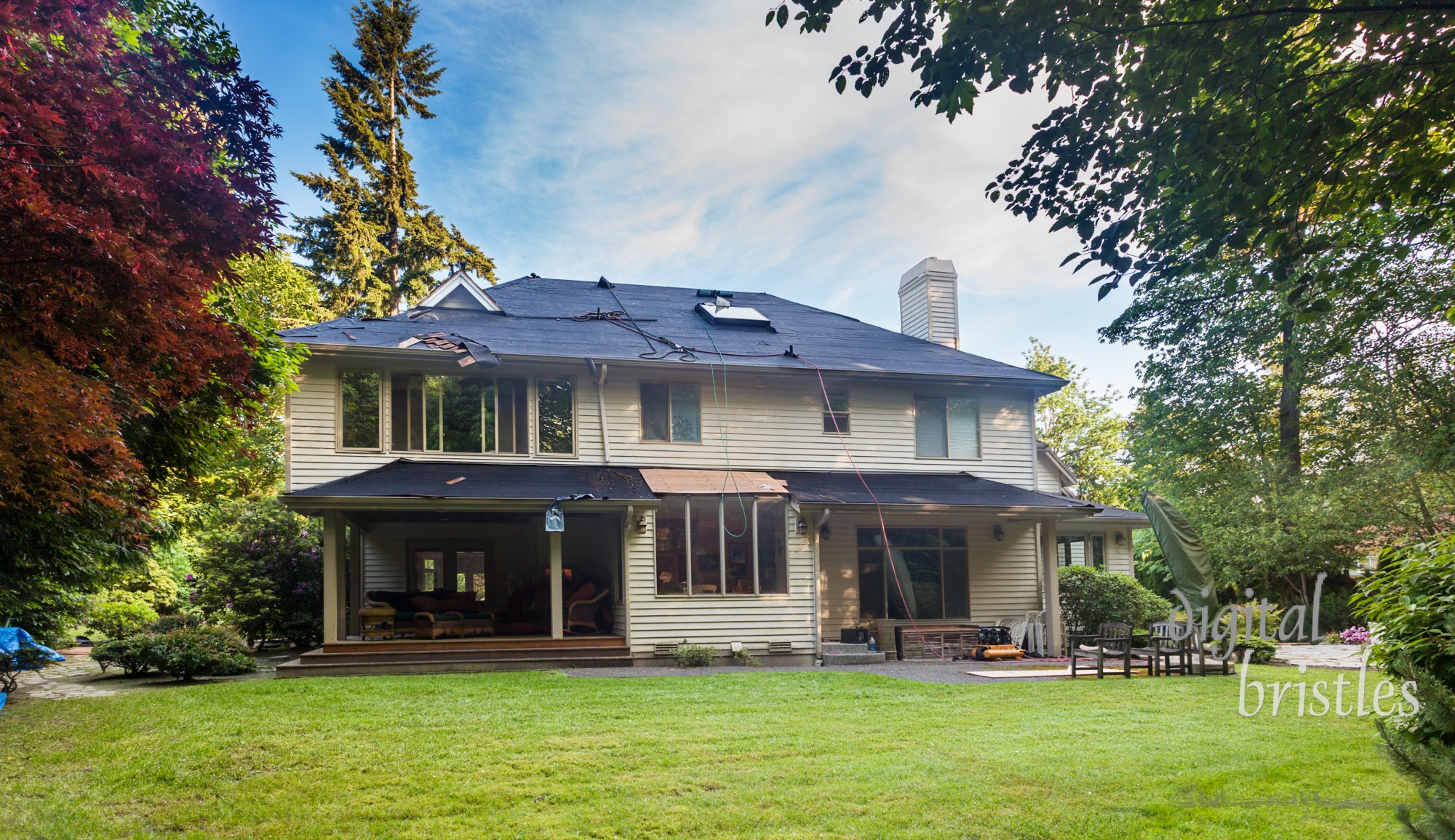 Suburban home in the middle of roof replacement. Old cedar shakes removed.