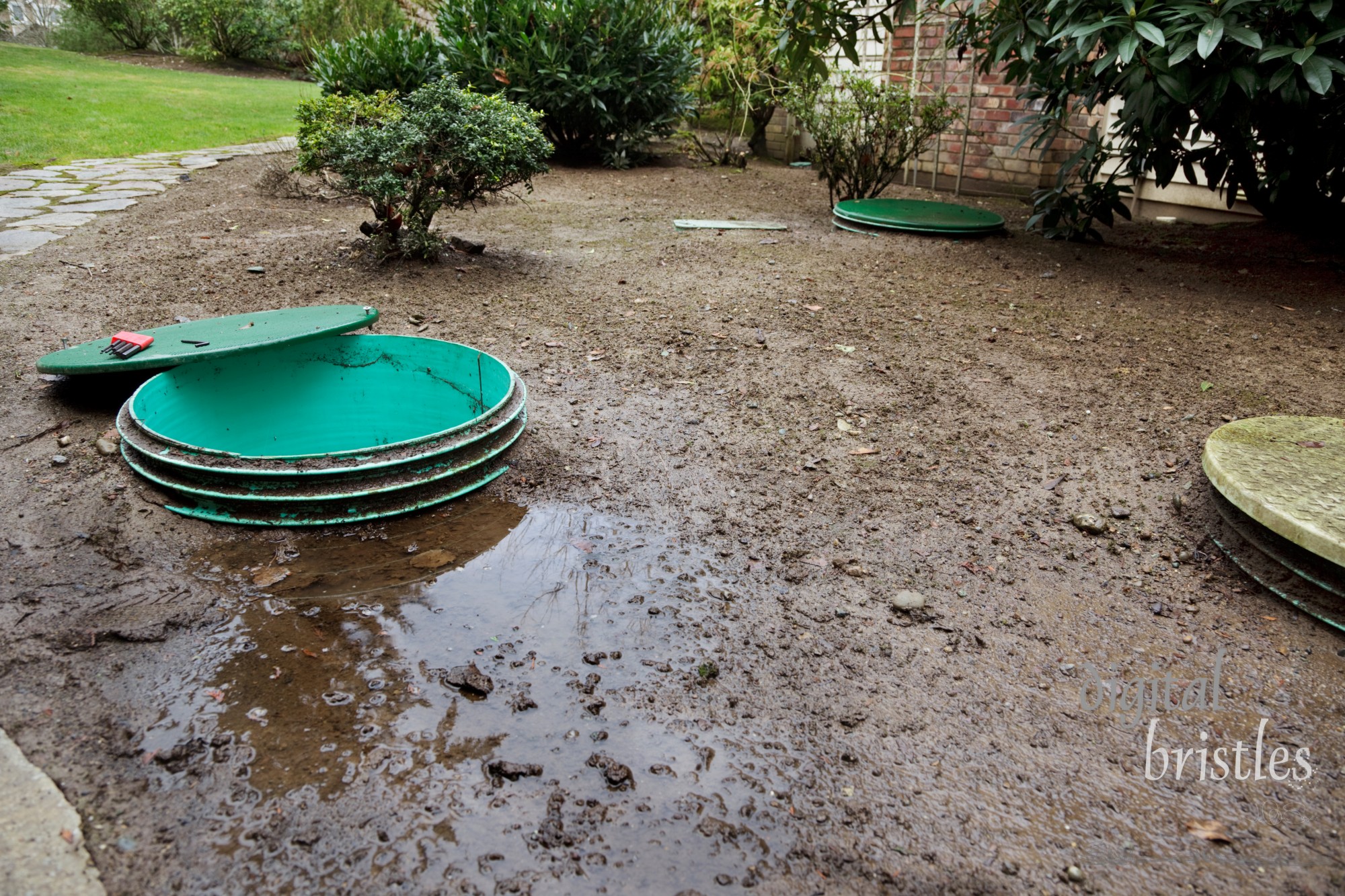 Opening the lids to investigate leaks around a septic system's tanks & pump chamber