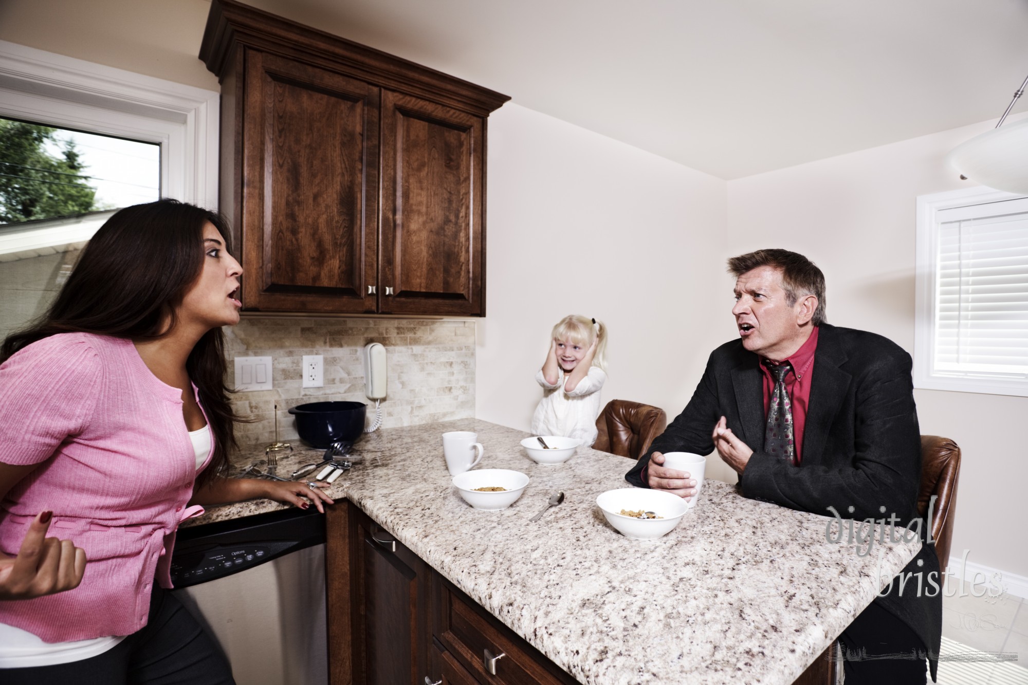 Husband and wife arguing over breakfast while their daughter watches & listens