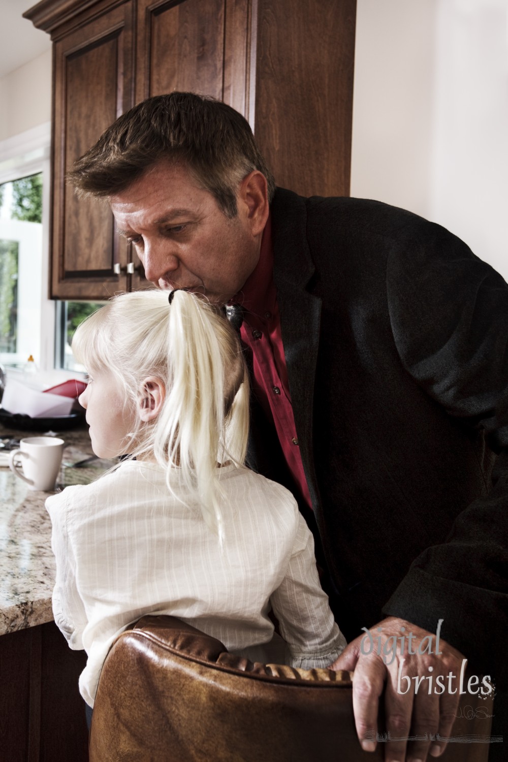 Dad kisses his daughter goodbye as he heads to work