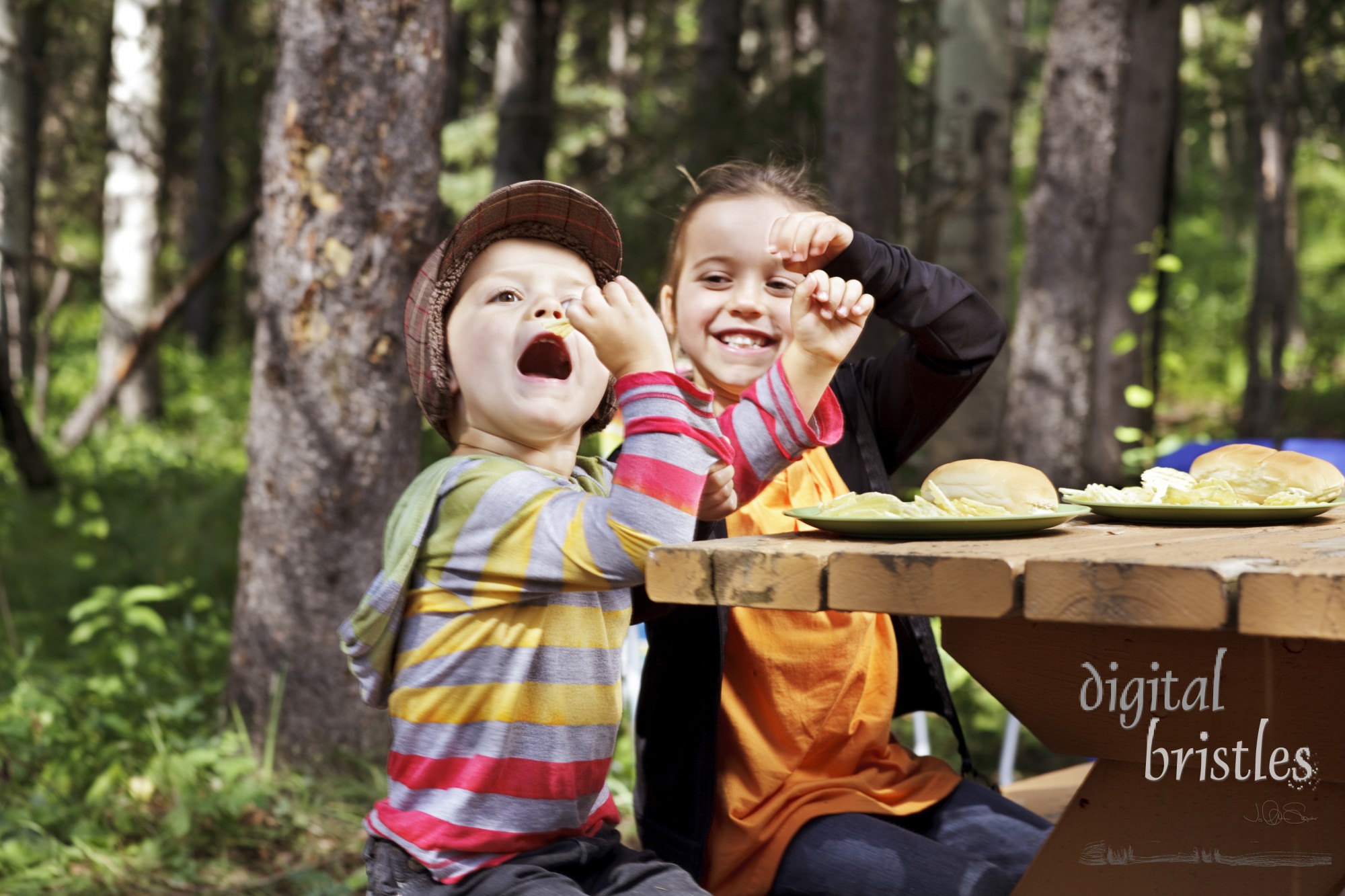 Young boy gets the potato chip in spite of his sister's attempts to stop him