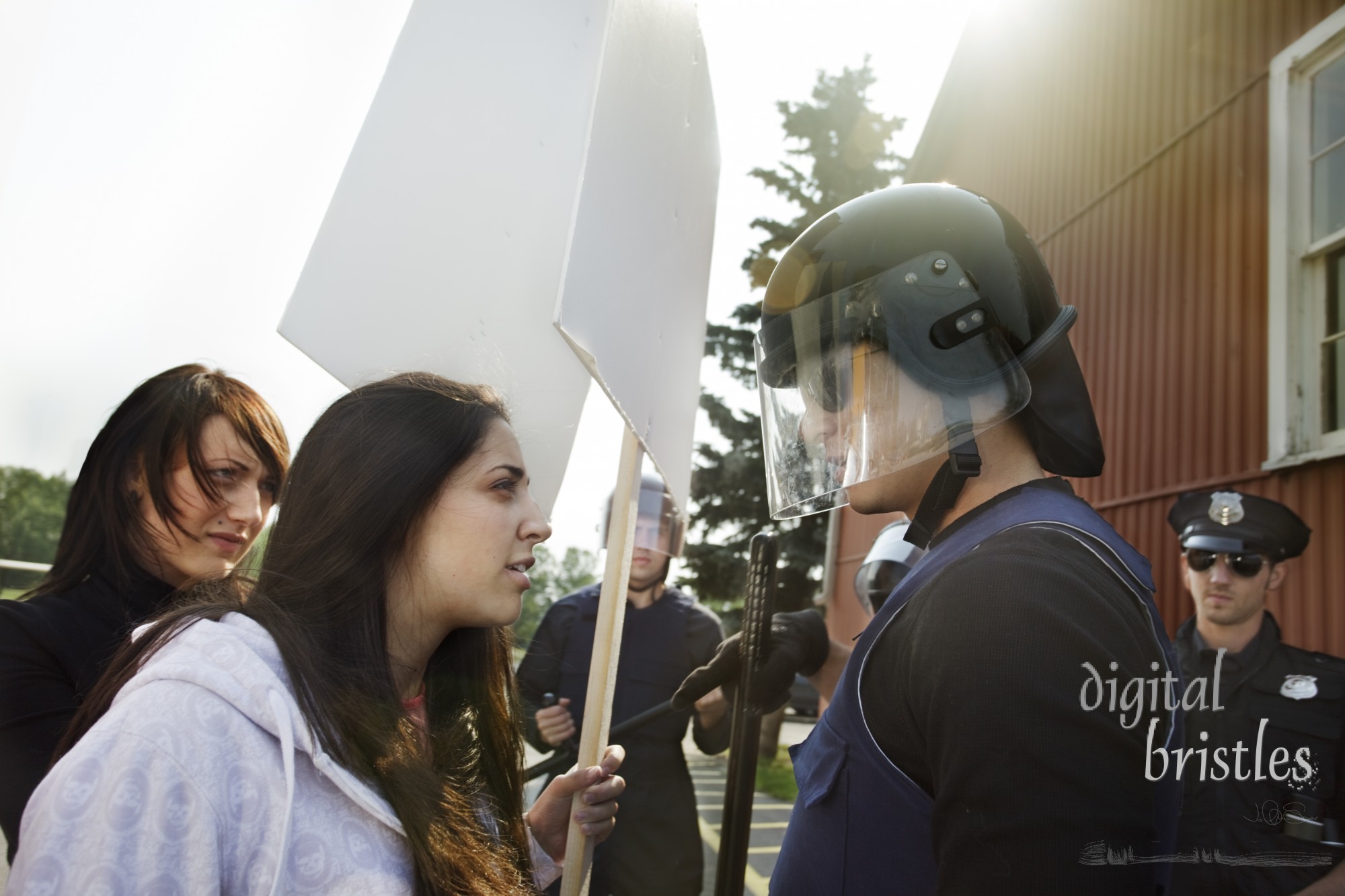 Protester tries to calmly work something out with the police officer