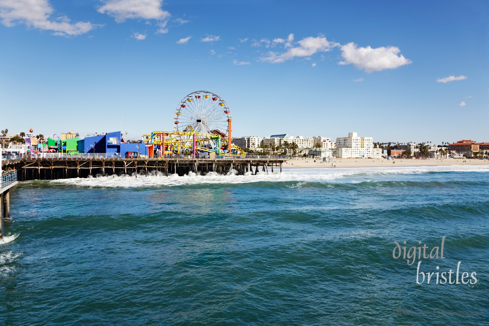 Amusement park on Santa Monica pier with the beach in the background