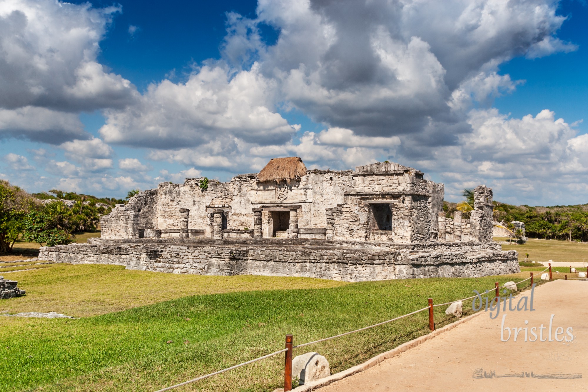 Mayan ruins at Tulum - the remains of the House of the Halach Uinic and a small thatched roof