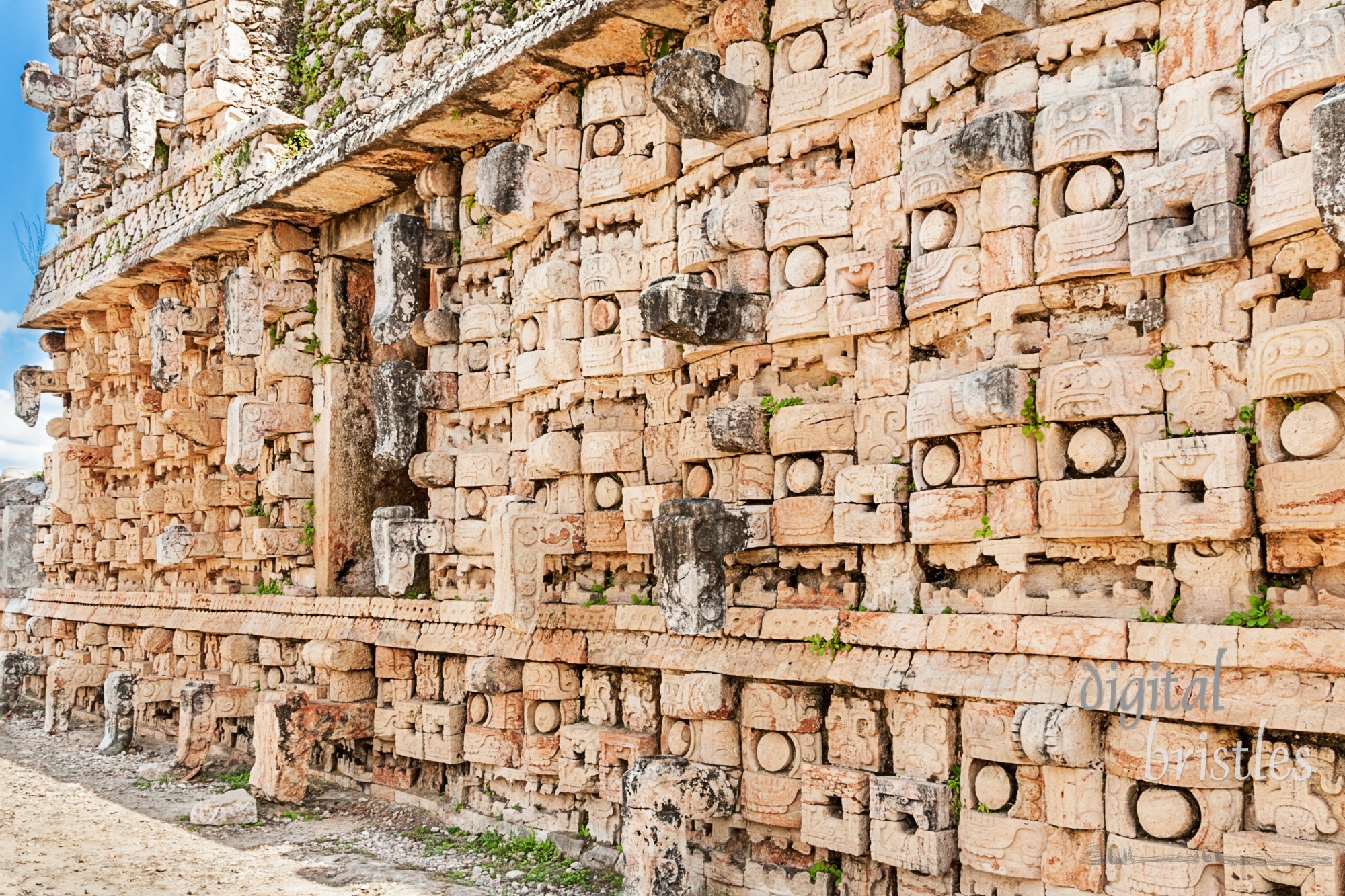 Front facade of the Palace of the Masks, Codz Poop, Kabah, a wall lined with masks of Chaac, the rain god