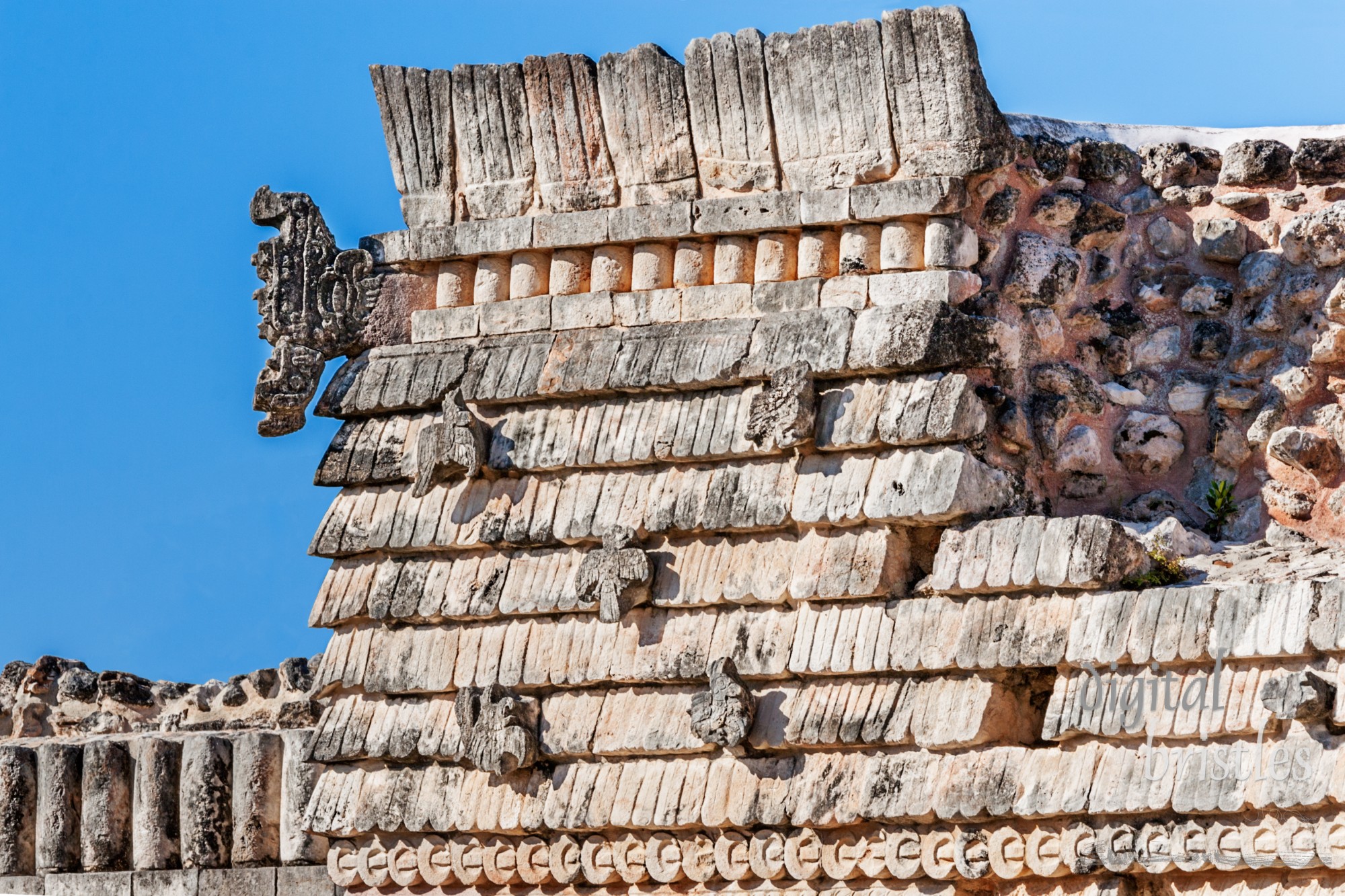 Partially restored roof of the House of the Birds with open serpent's mouth at the edge, Uxmal, Mexico