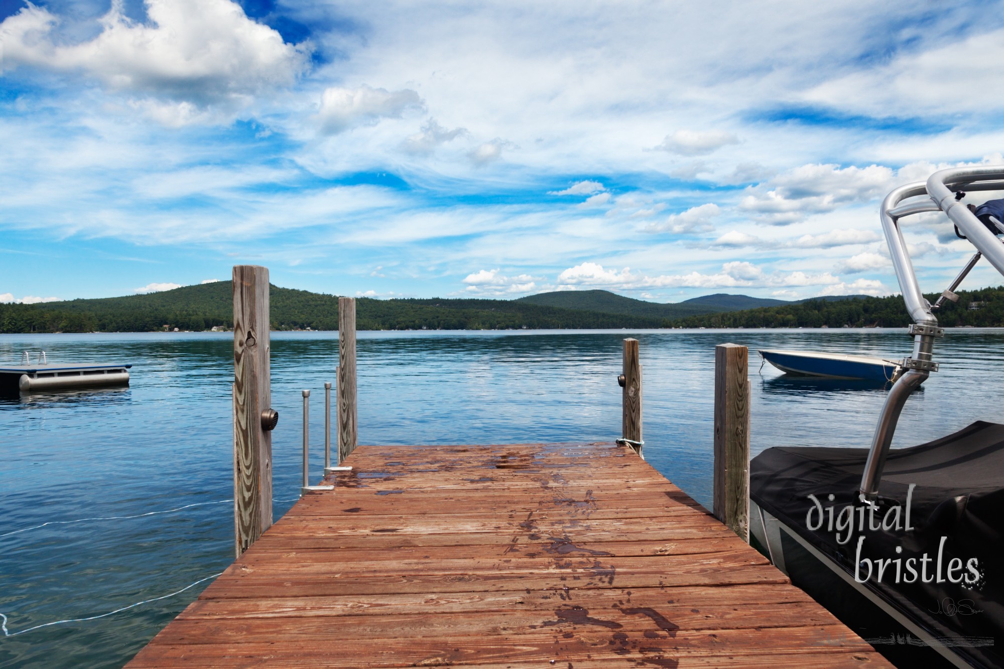 Dock with wet footprints on a warm summer lake