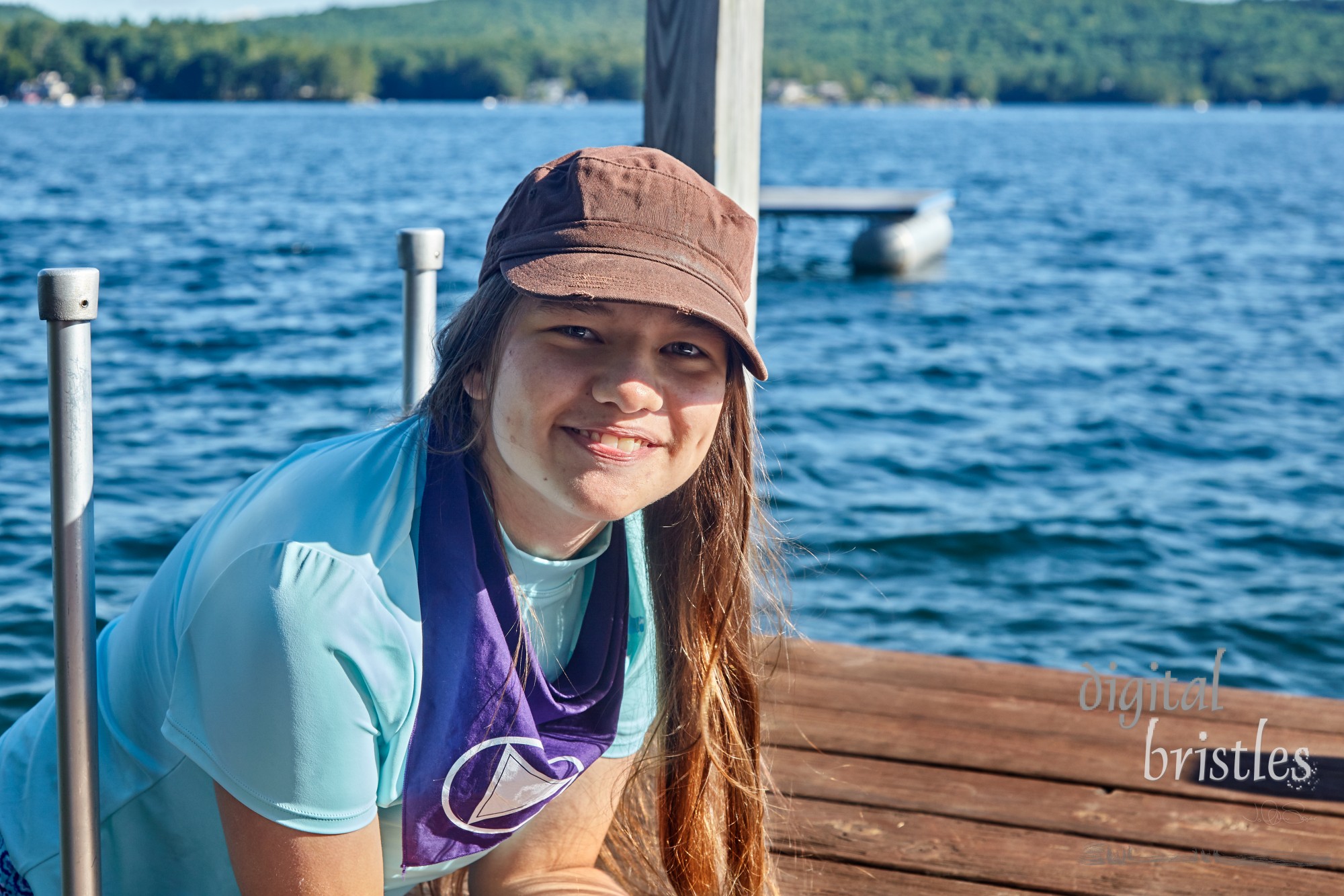 Teenager slowly climbing into a cool lake for a morning swim