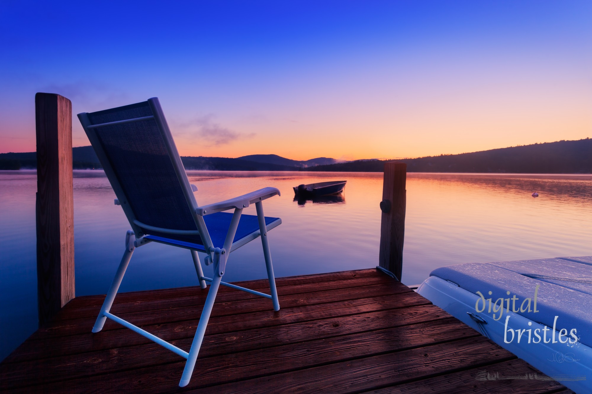 Chair at the end of the dock on a calm summer morning