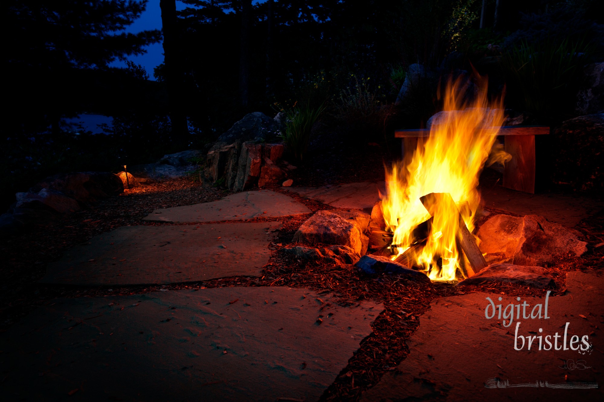 Warm glow of an outside fire pit on a summer evening